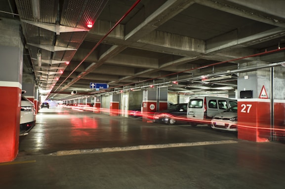Cars parked in a dimly lit underground garage.