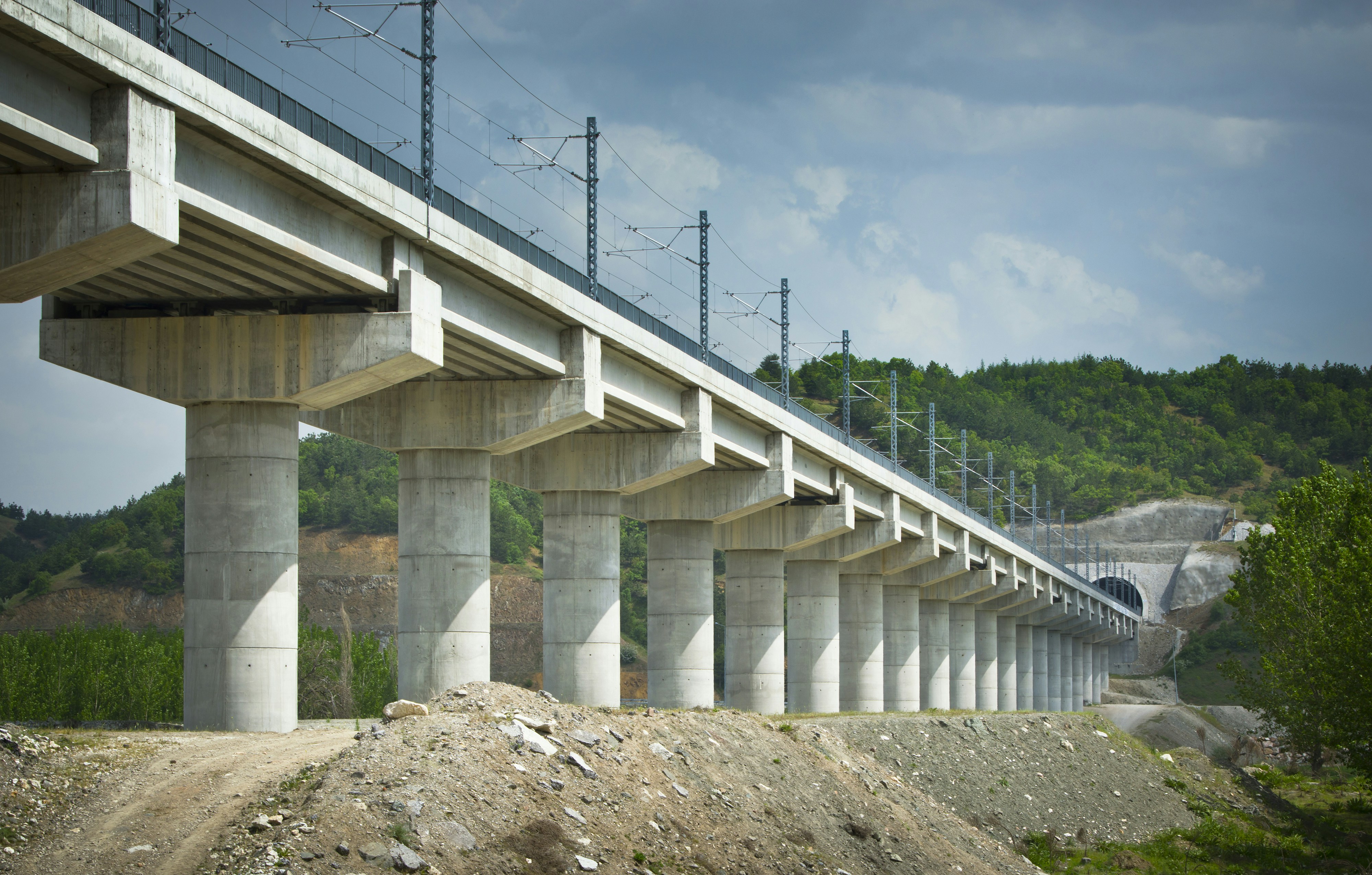 Elevated train tracks crossing a rural landscape