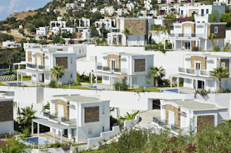 Modern white houses on a hillside.