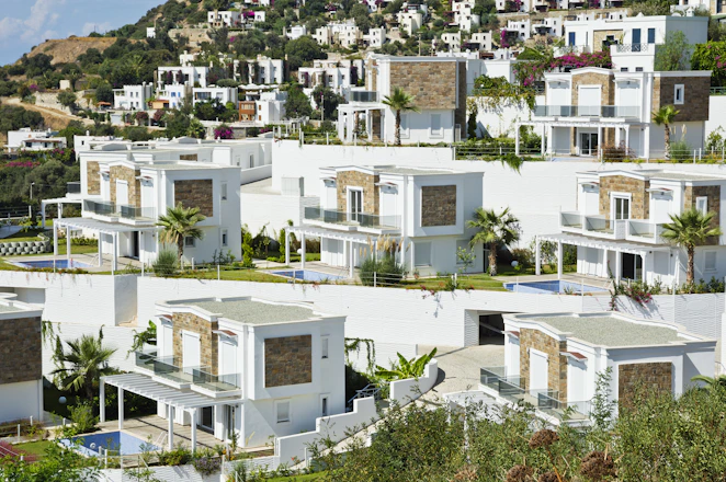 Modern white houses on a hillside.