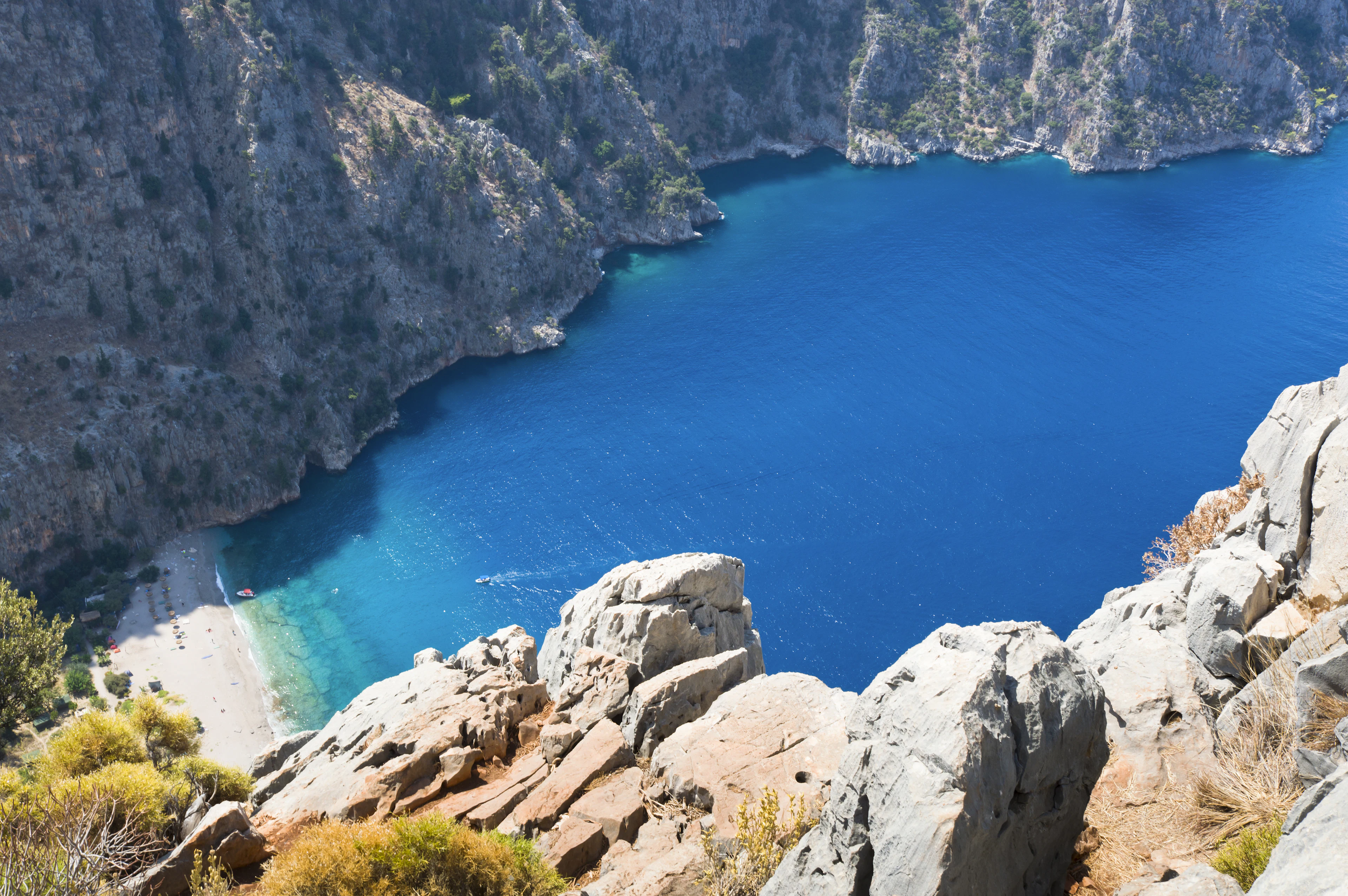 Butterfly Valley from above: turquoise water, a strip of sand and sheer cliffs near Fethiye
