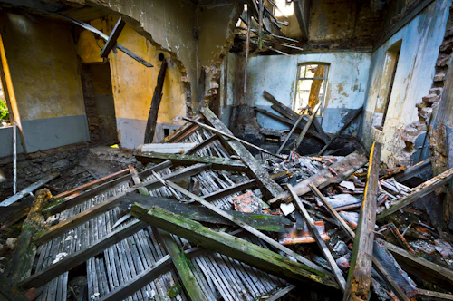 Interior demolition — gutted room with debris and structural strip-out