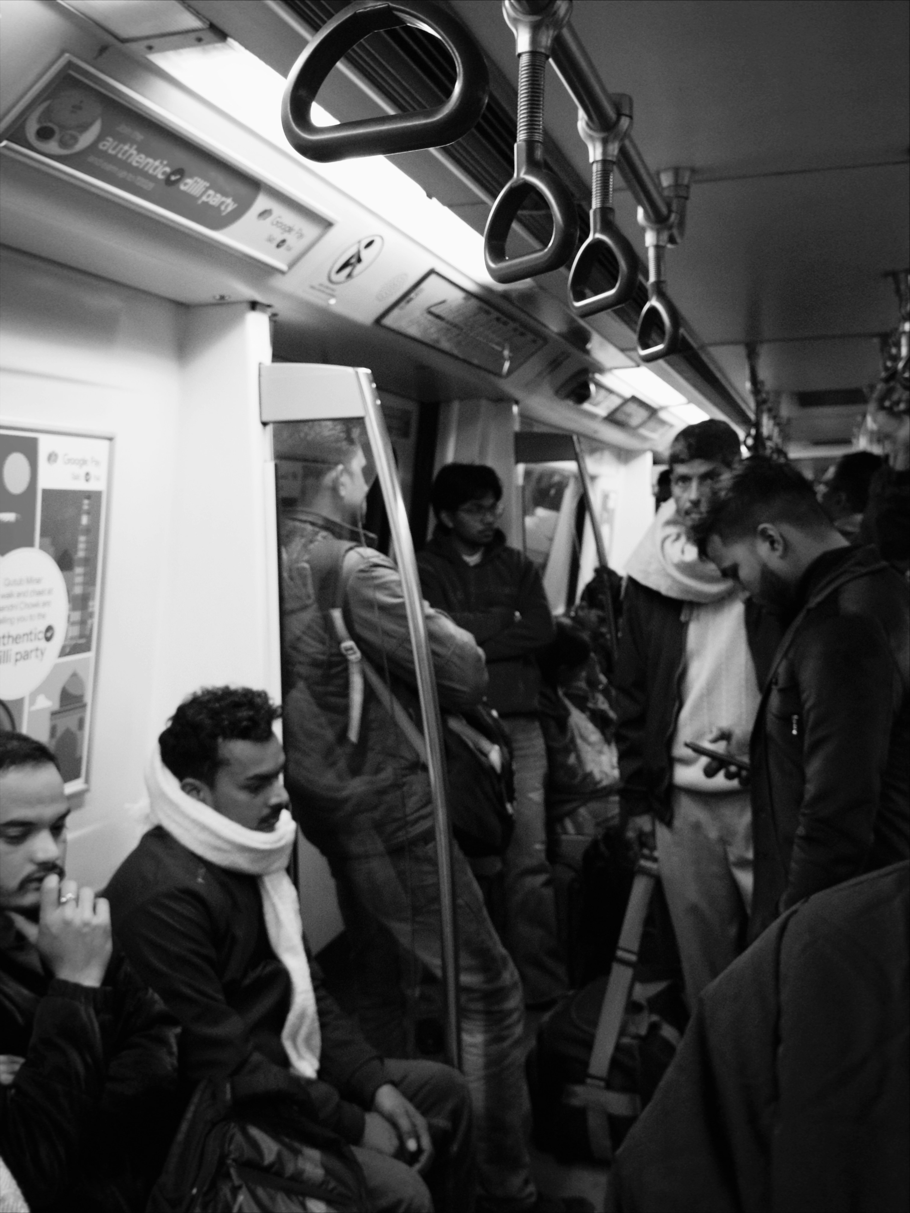 People riding on a crowded subway train