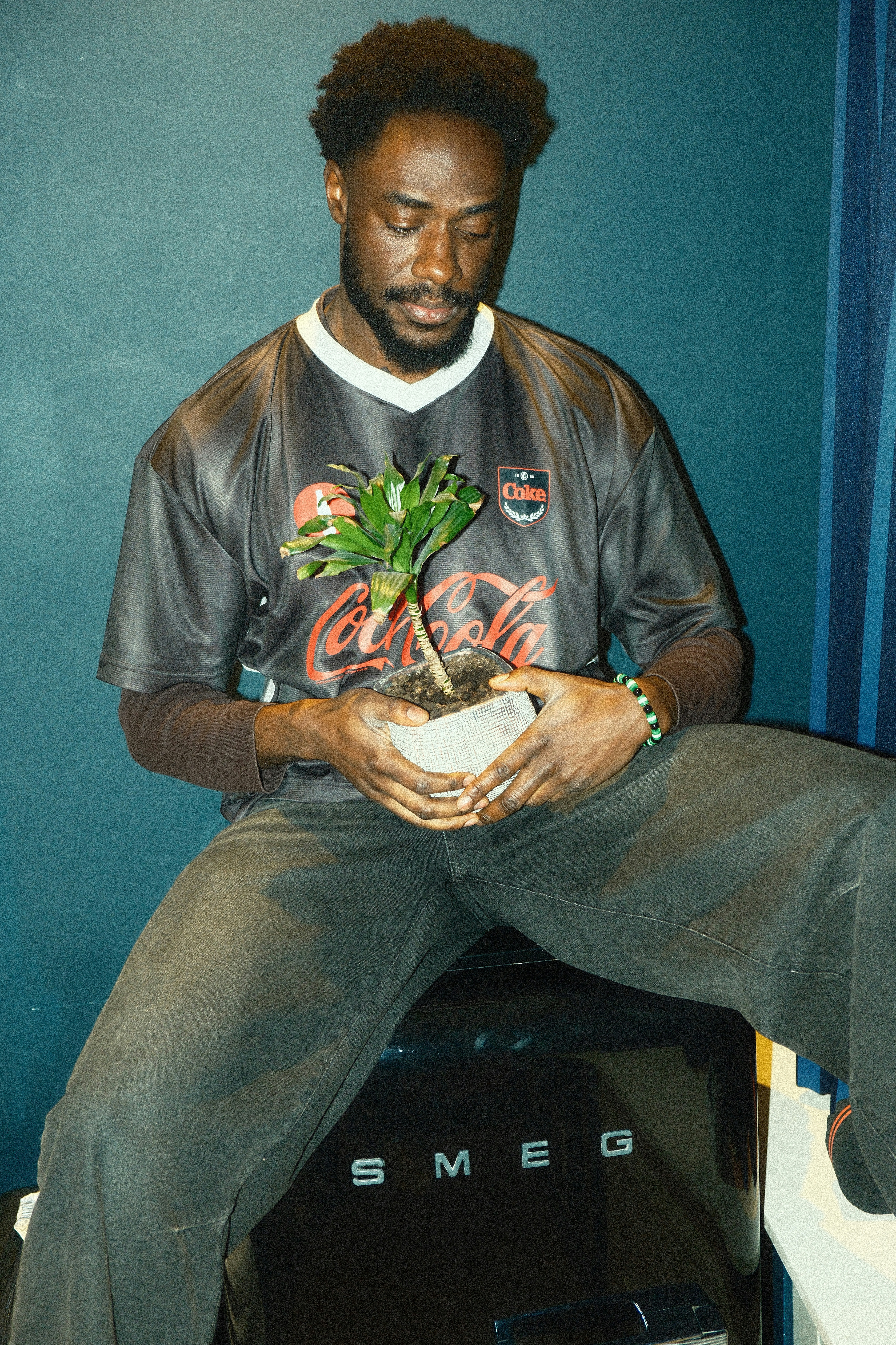 Man holding a small potted plant