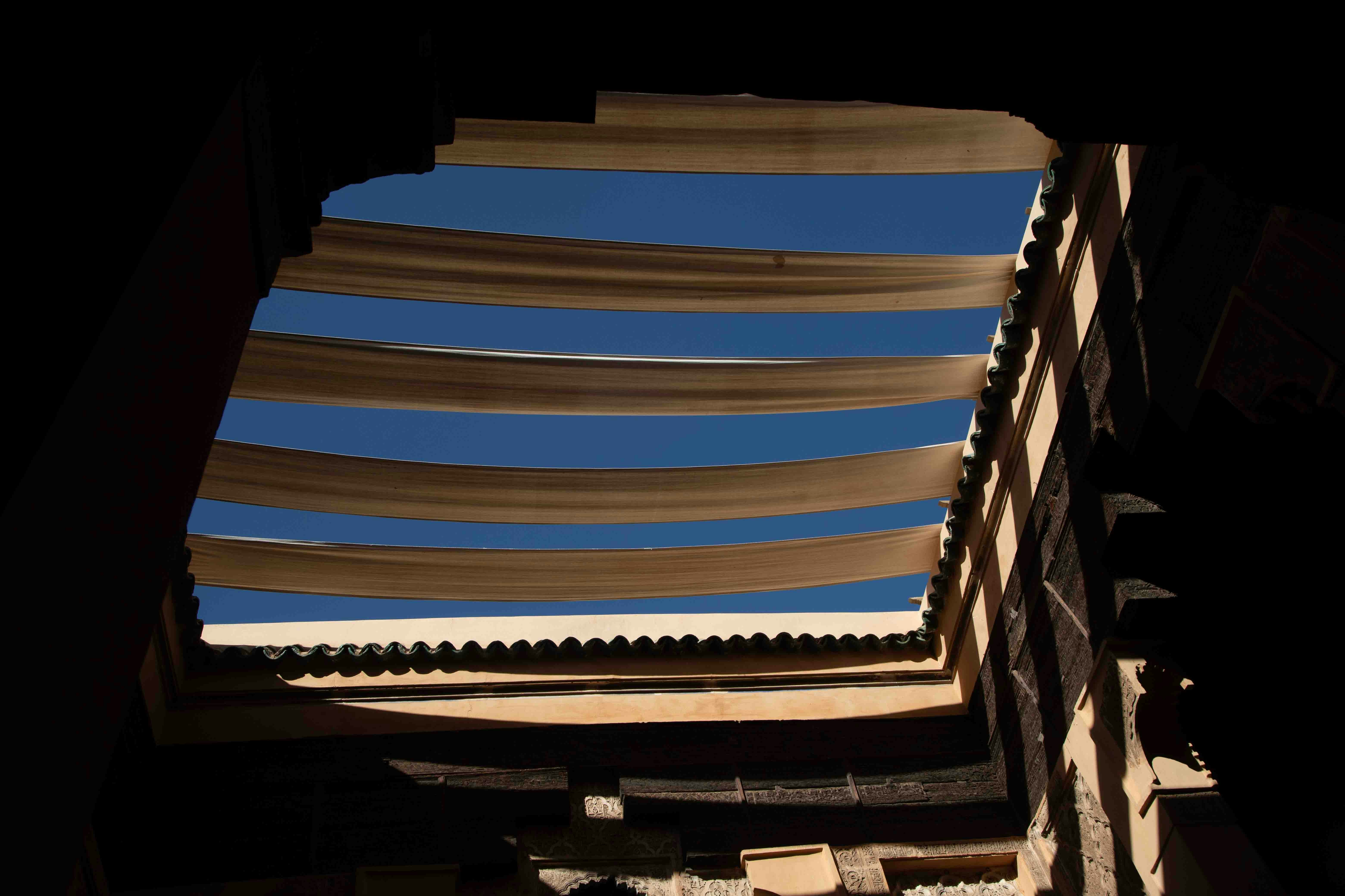 View of blue sky through architectural openings.