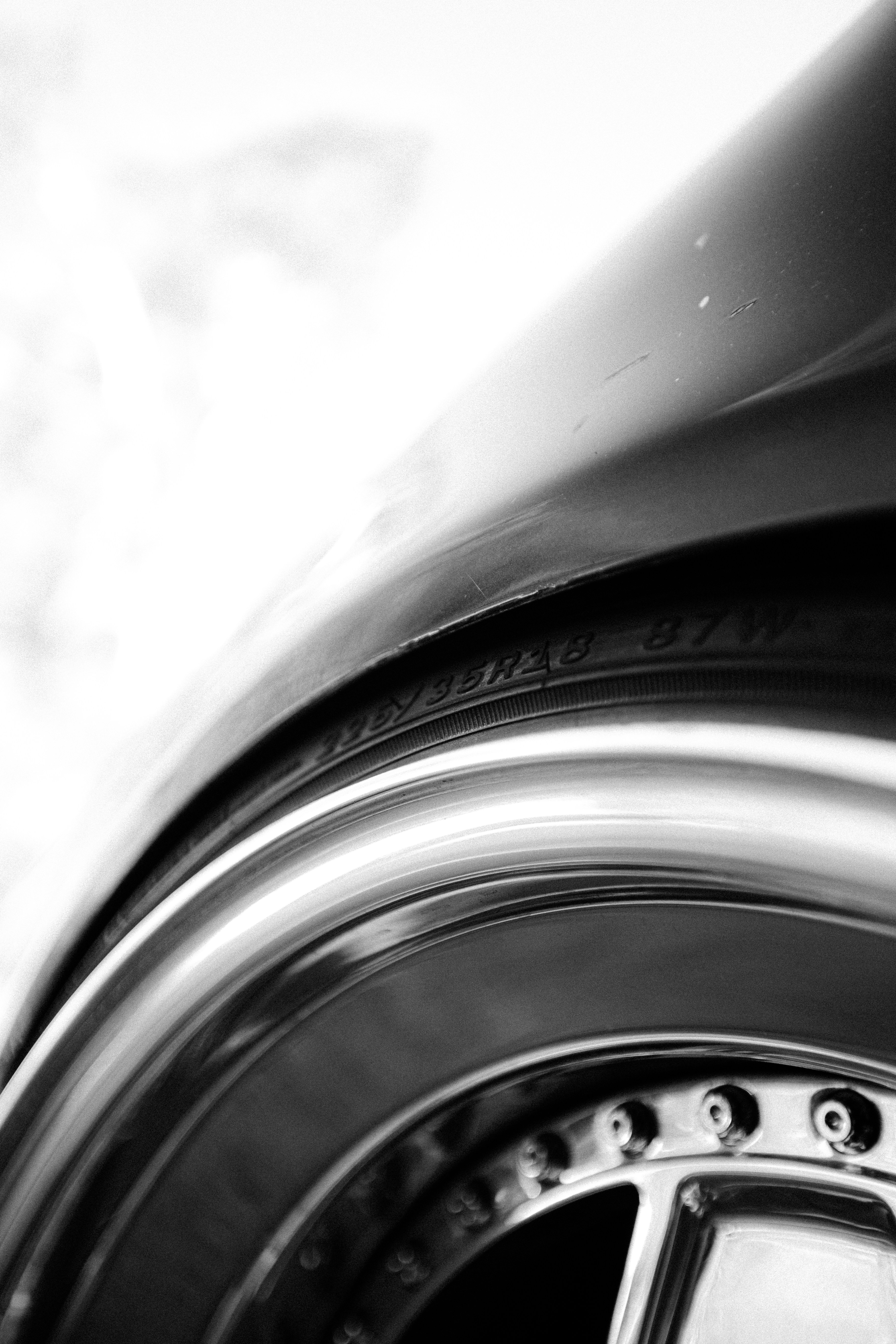 Close-up of a car's chrome wheel and tire.