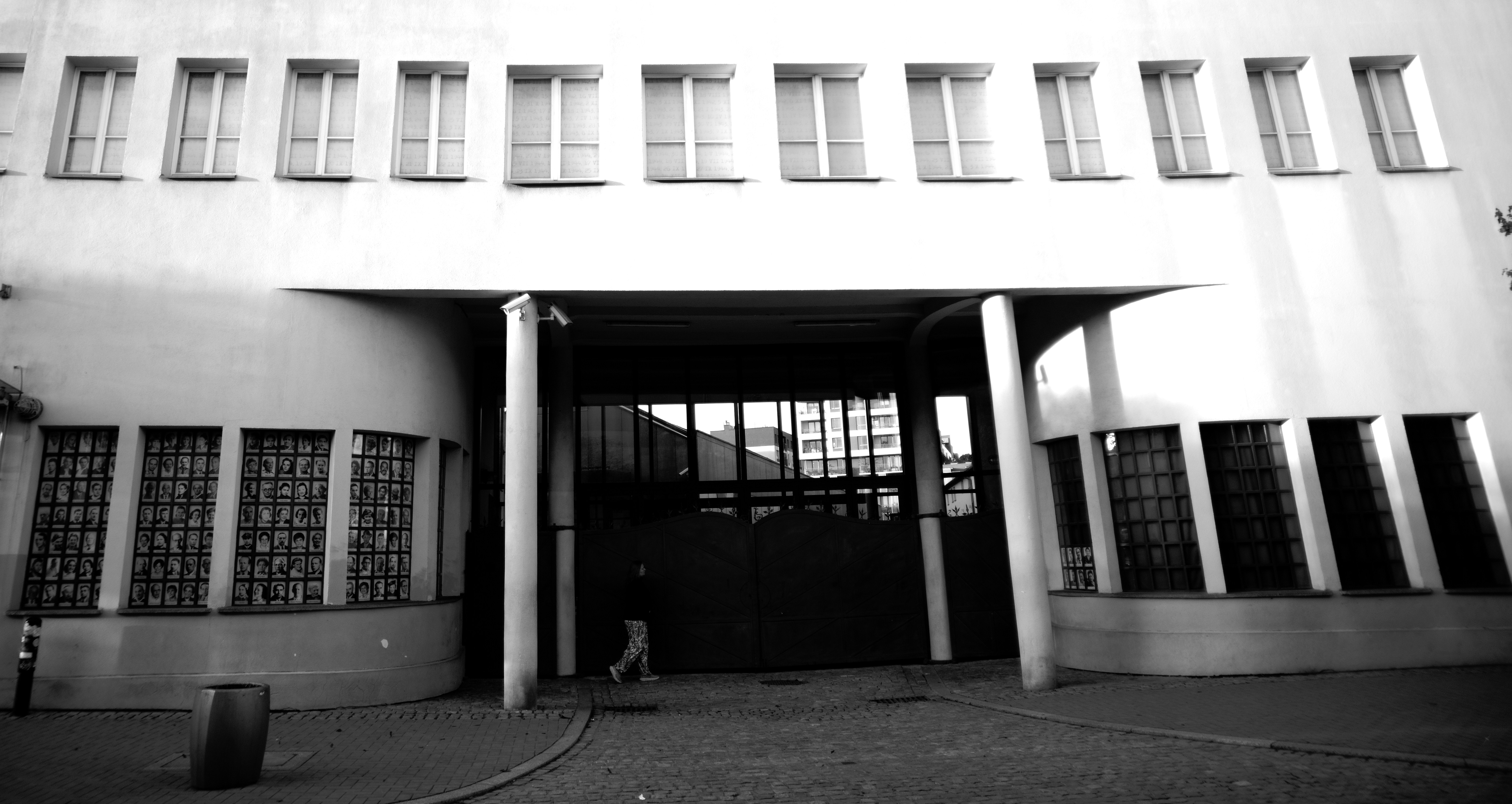 Modern building entrance with arched walkway and windows