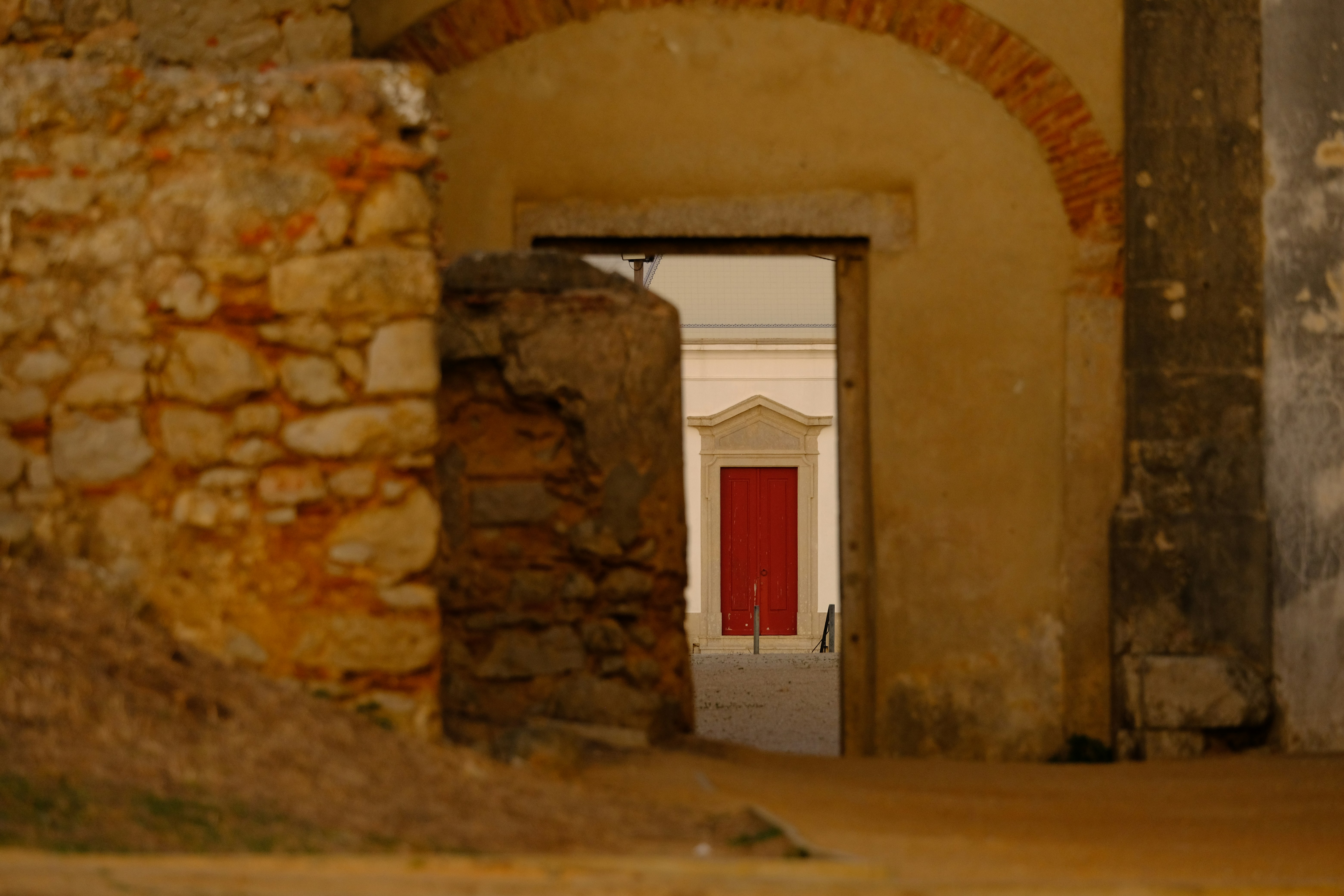 Archway leading to a room with red doors