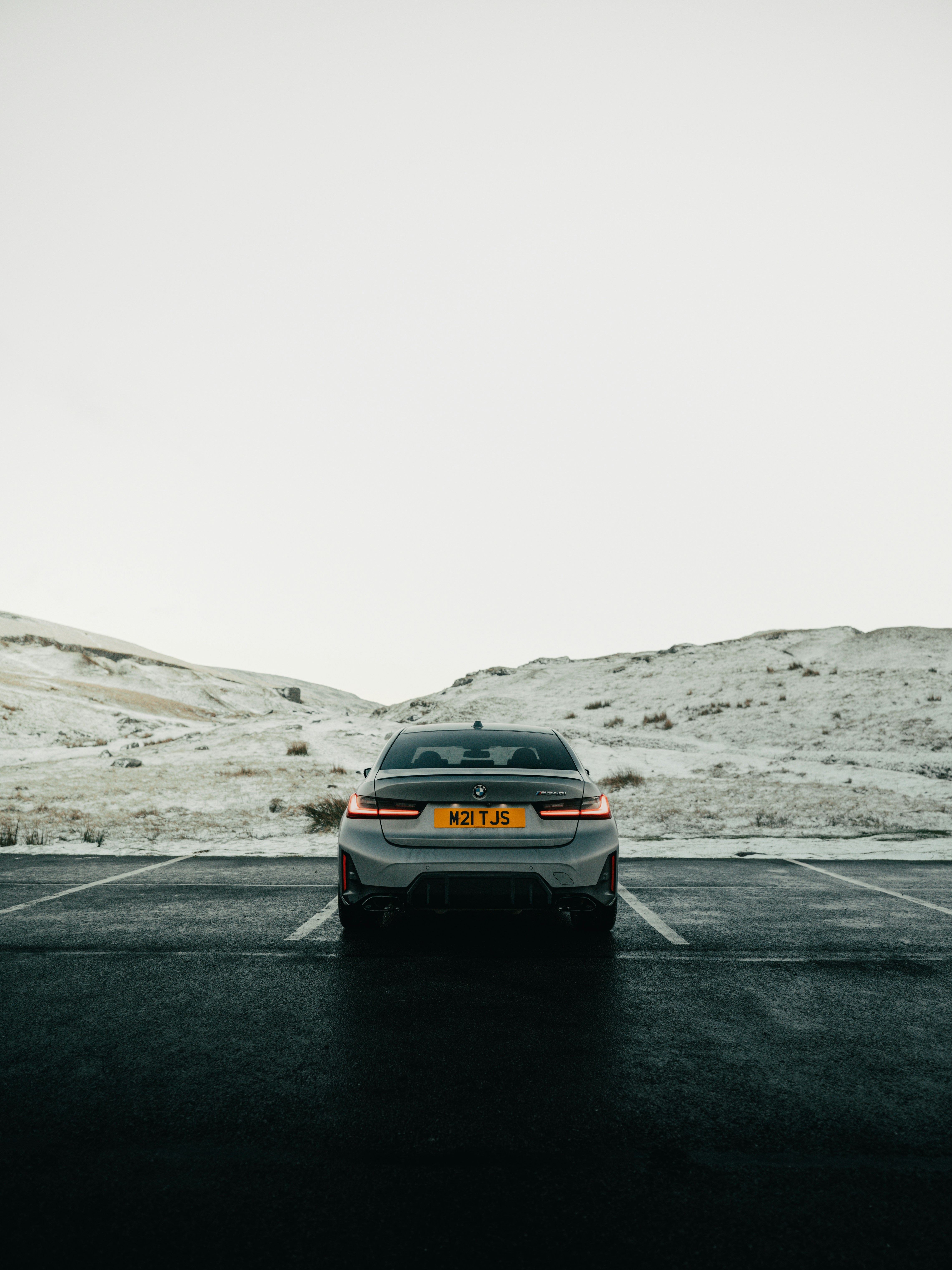A grey car parked in a snowy landscape