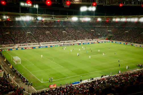 Soccer game played in a packed stadium at night