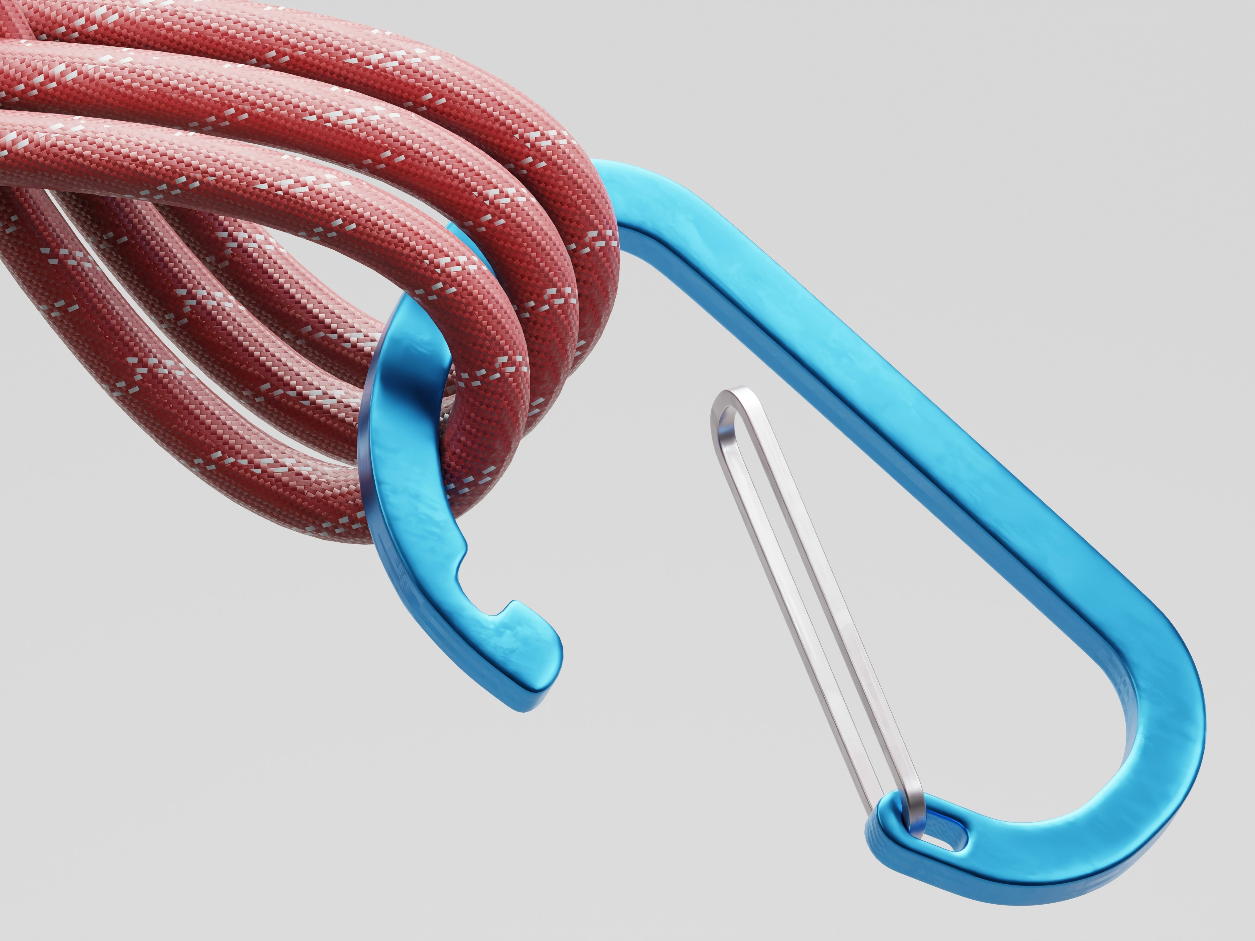 Close-up of a blue carabiner clipped to a red rope