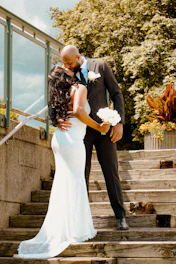 Bride and groom kissing on outdoor stairs