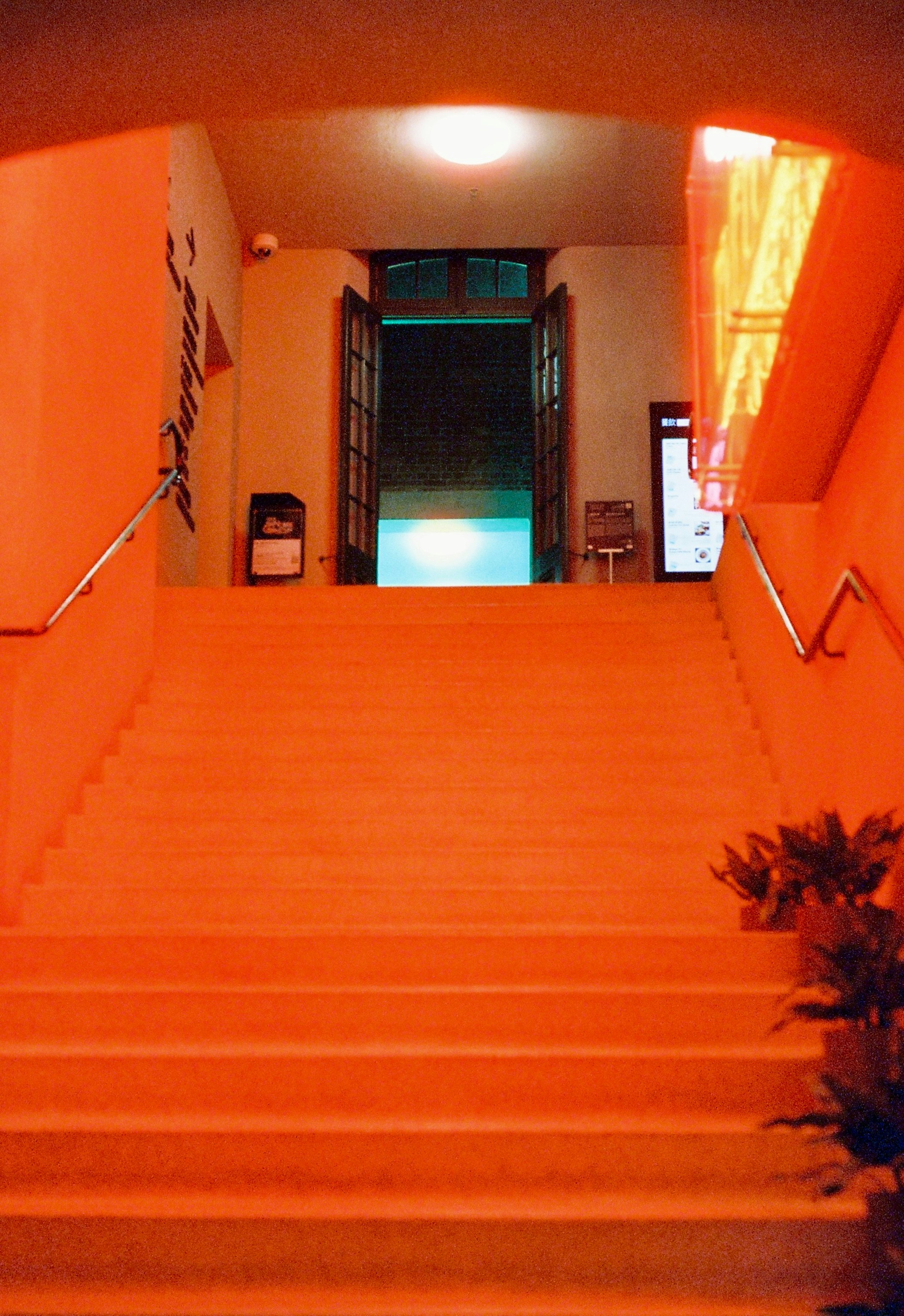 Orange staircase leading to an open doorway