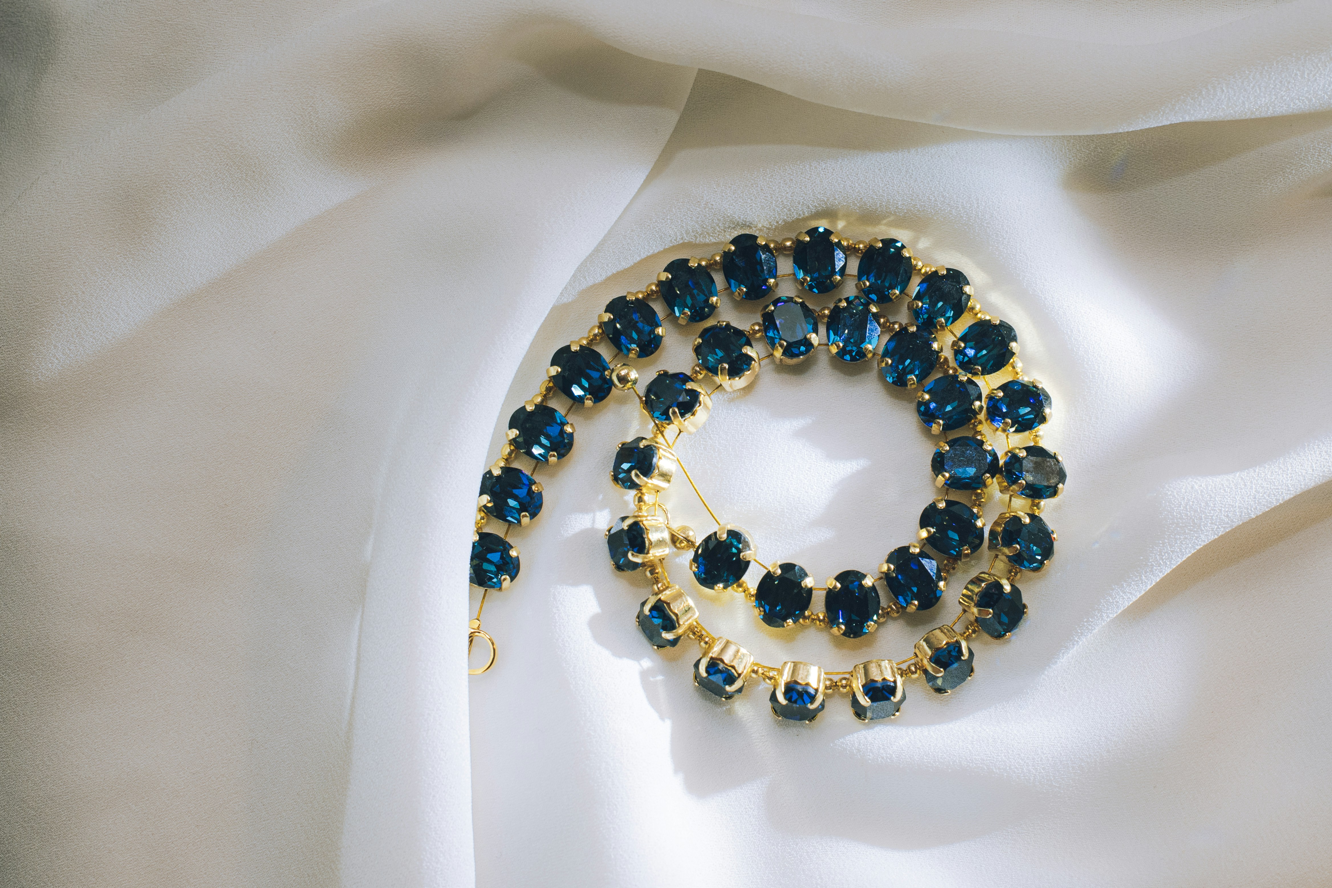 Elegant necklace featuring blue crystals paired with a refined golden chain
