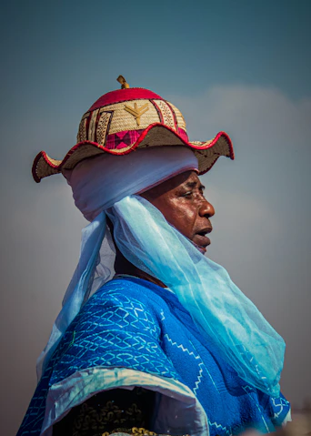 Woman in traditional headdress and blue clothing