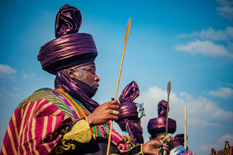 Men in traditional colorful attire and headwraps