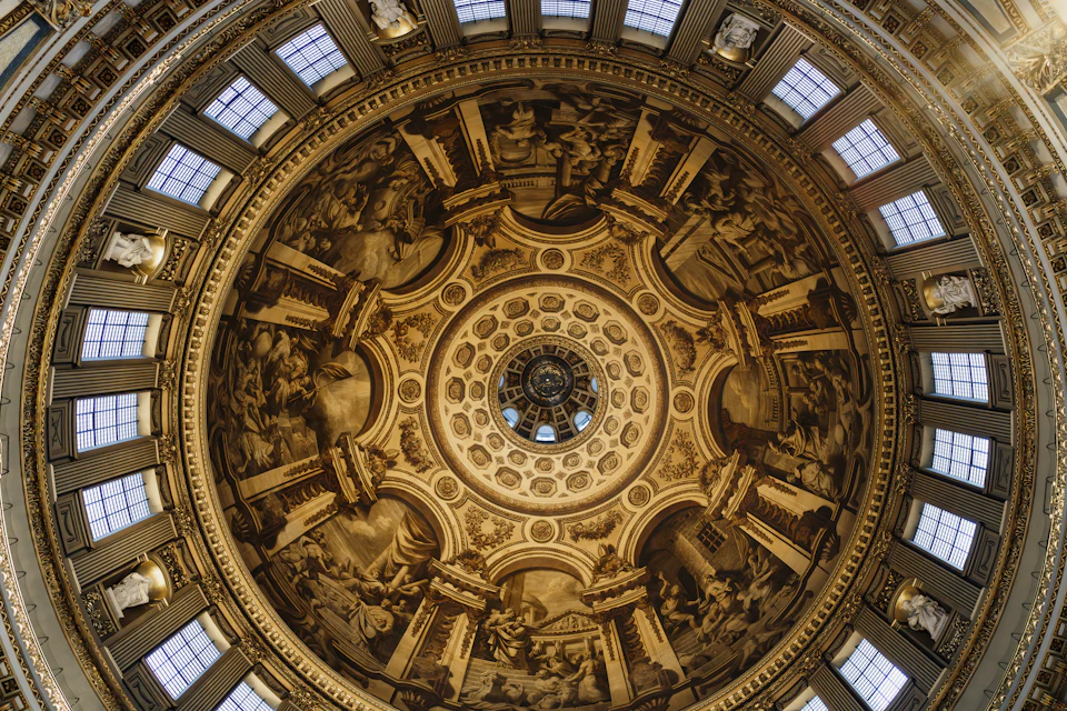 View from below inside St. Peter's Basilica dome, showcasing intricate carvings and architecture