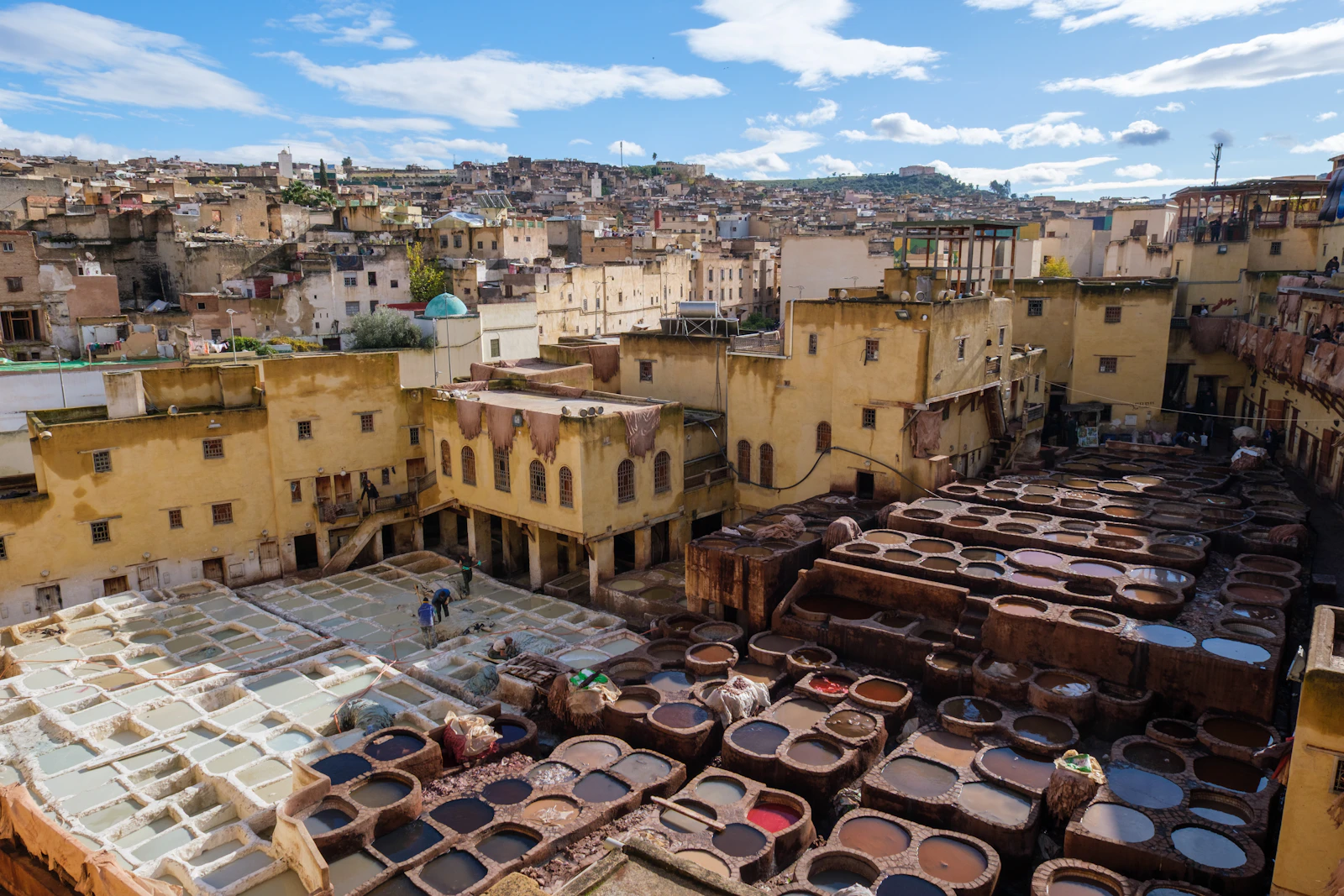 Traditional leather dye vats and cityscape in Fes, Morocco