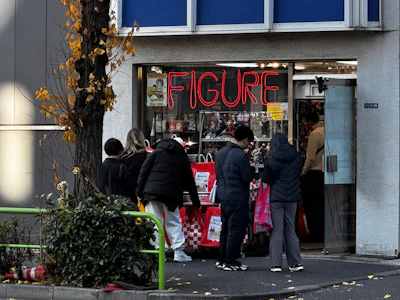 Shoppers browsing outside a figure and collectibles shop, Nakano Broadway, Tokyo