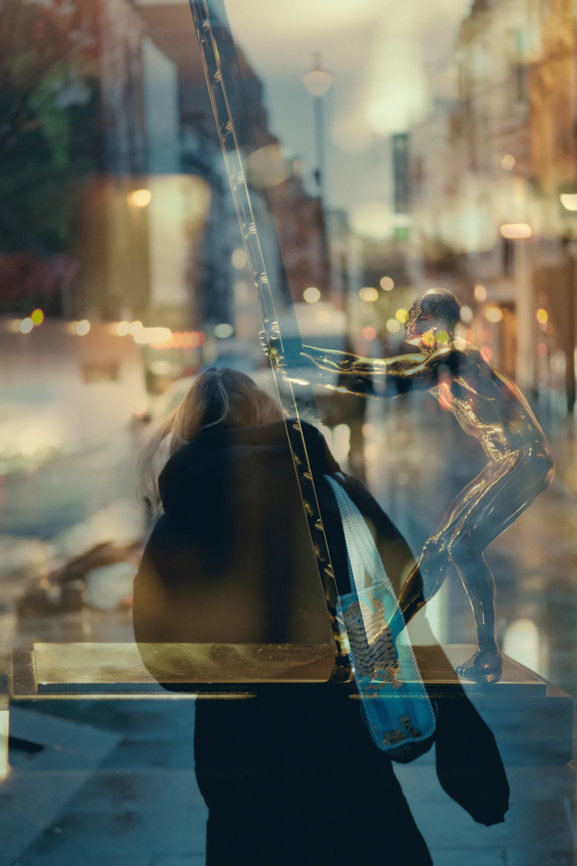 Reflection of a mannequin in a shop window