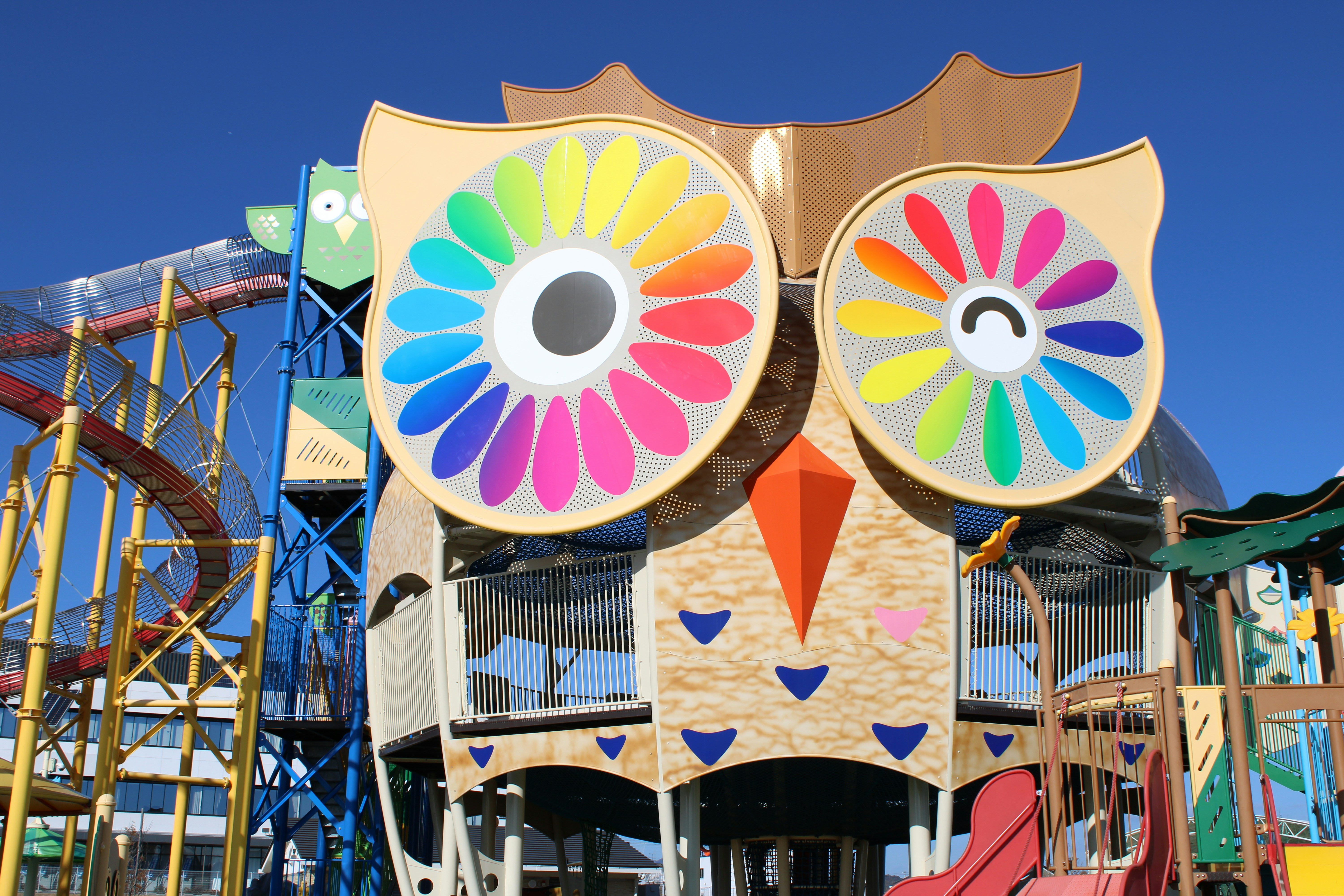 A large, colorful owl-shaped playground structure.