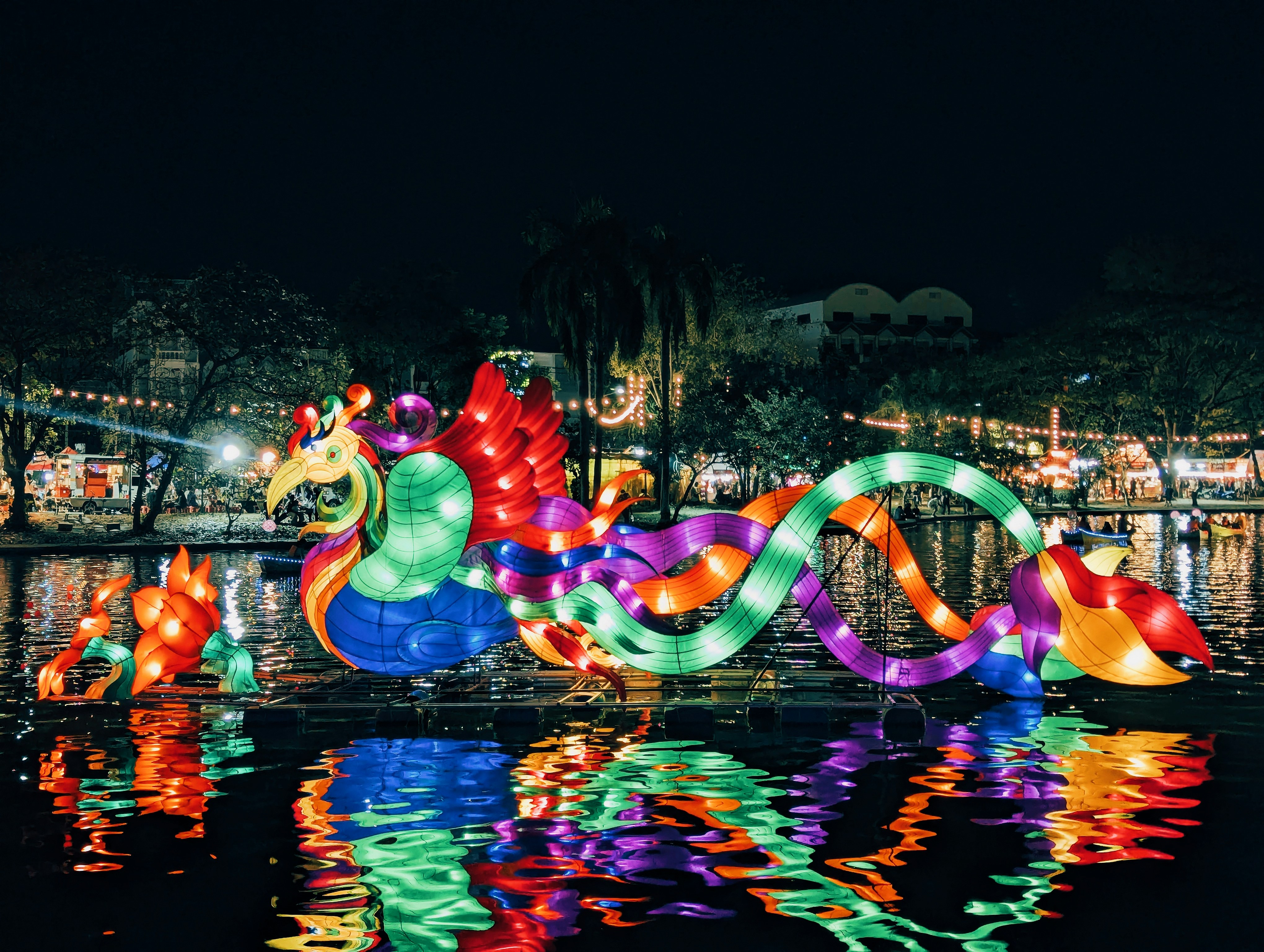 Colorful dragon lantern floats on water at night