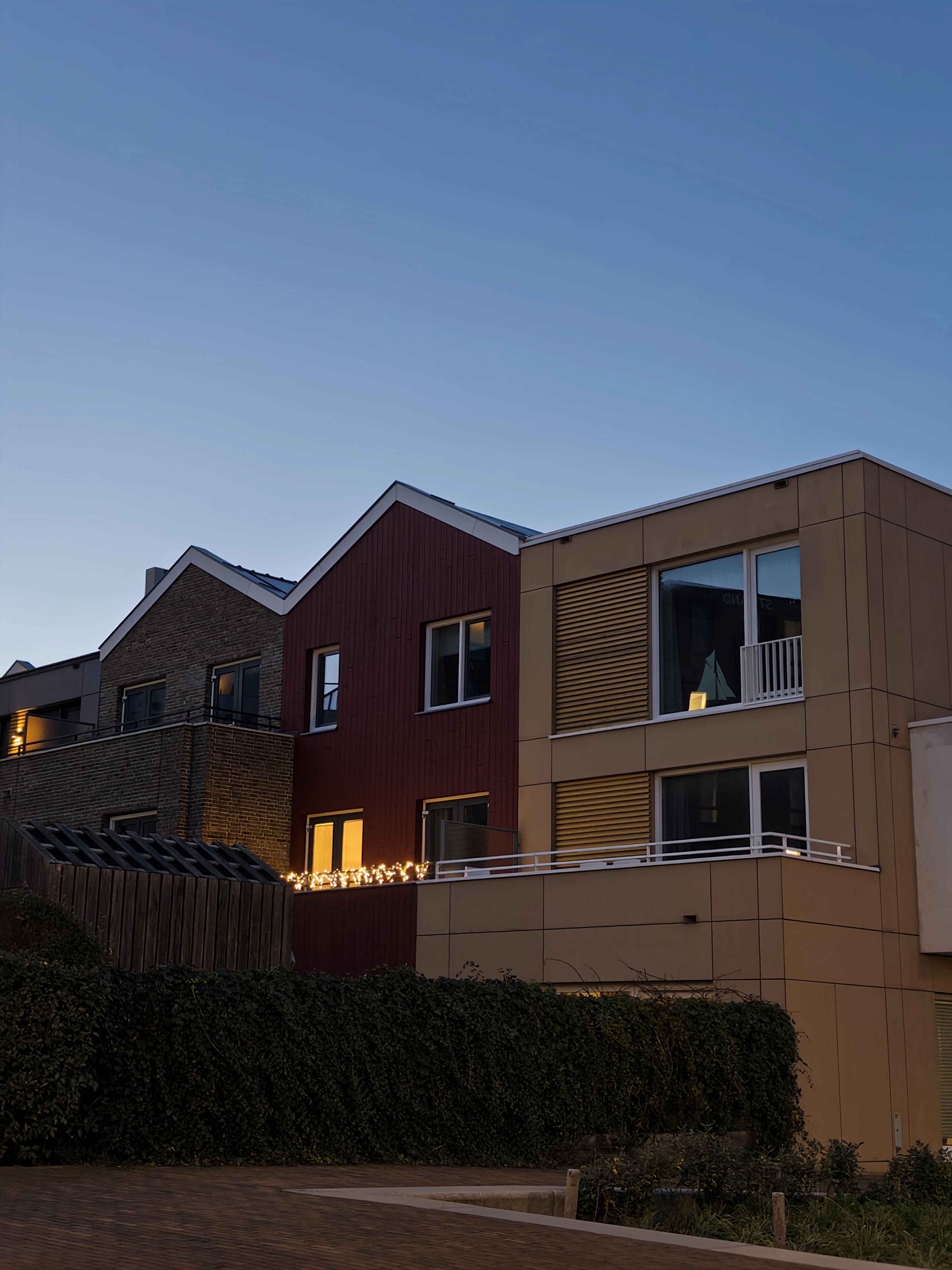Modern family houses lit up at dusk