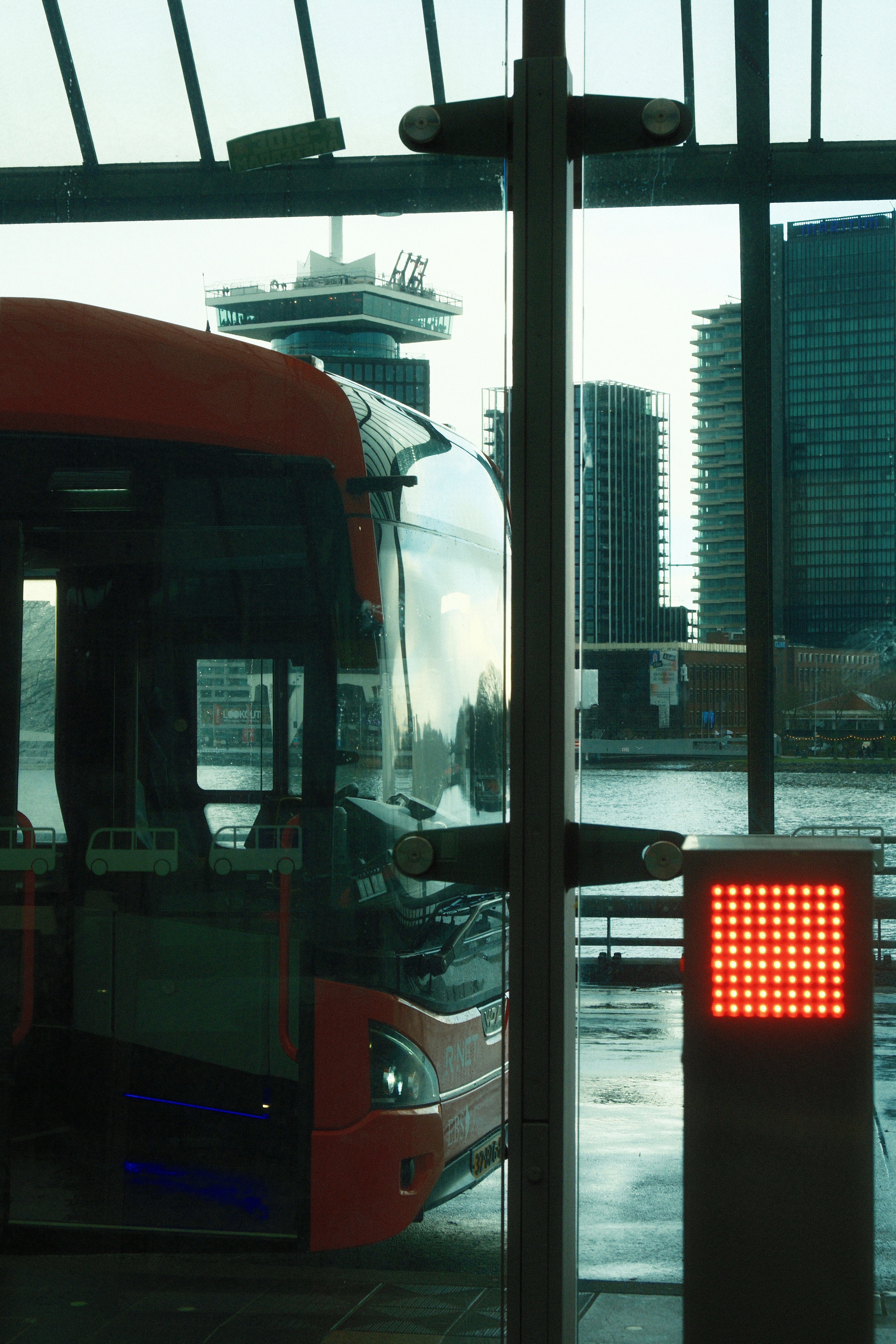 Modern bus at station with city skyline