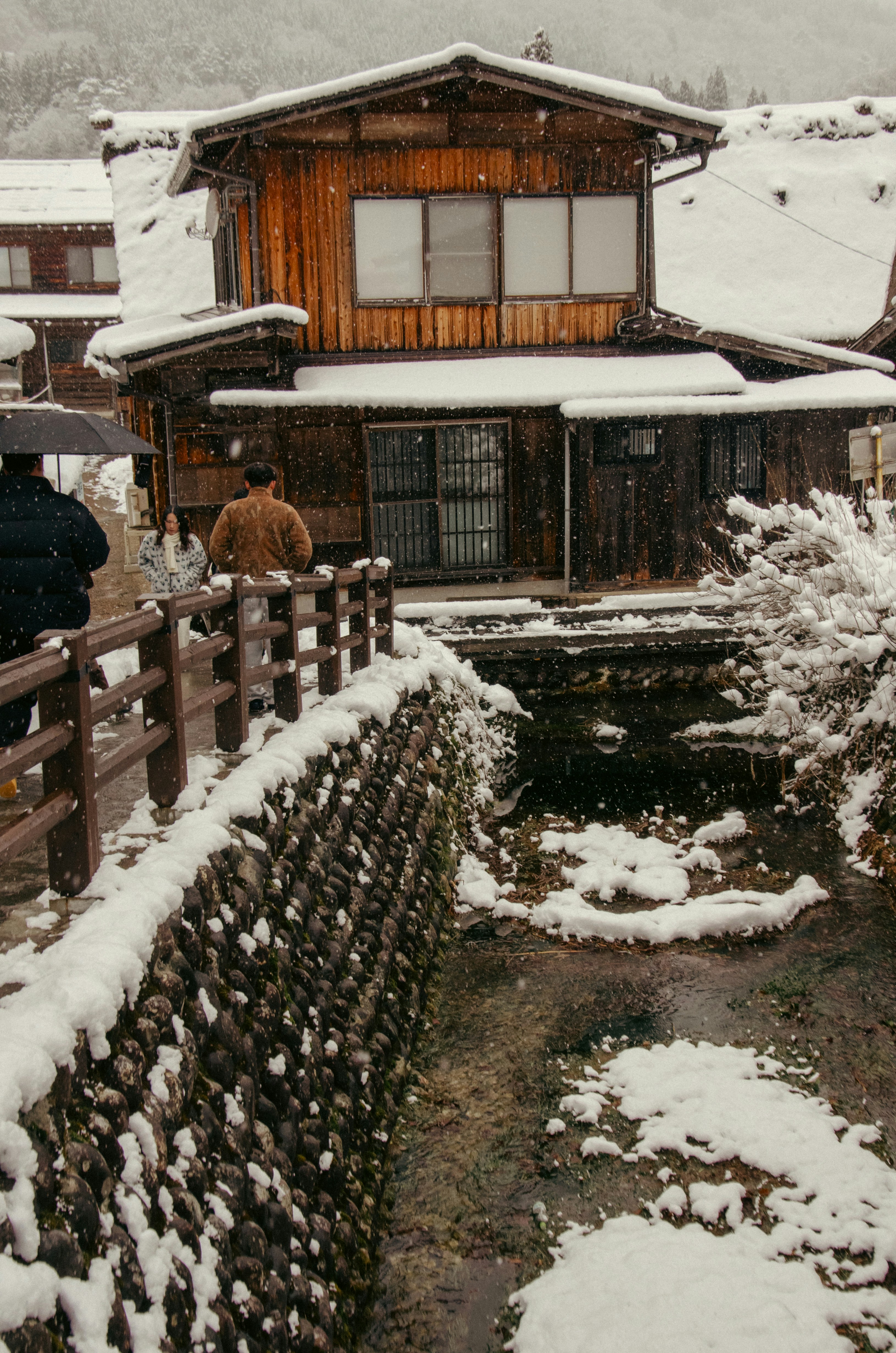 Wooden houses in a village during snowfall
