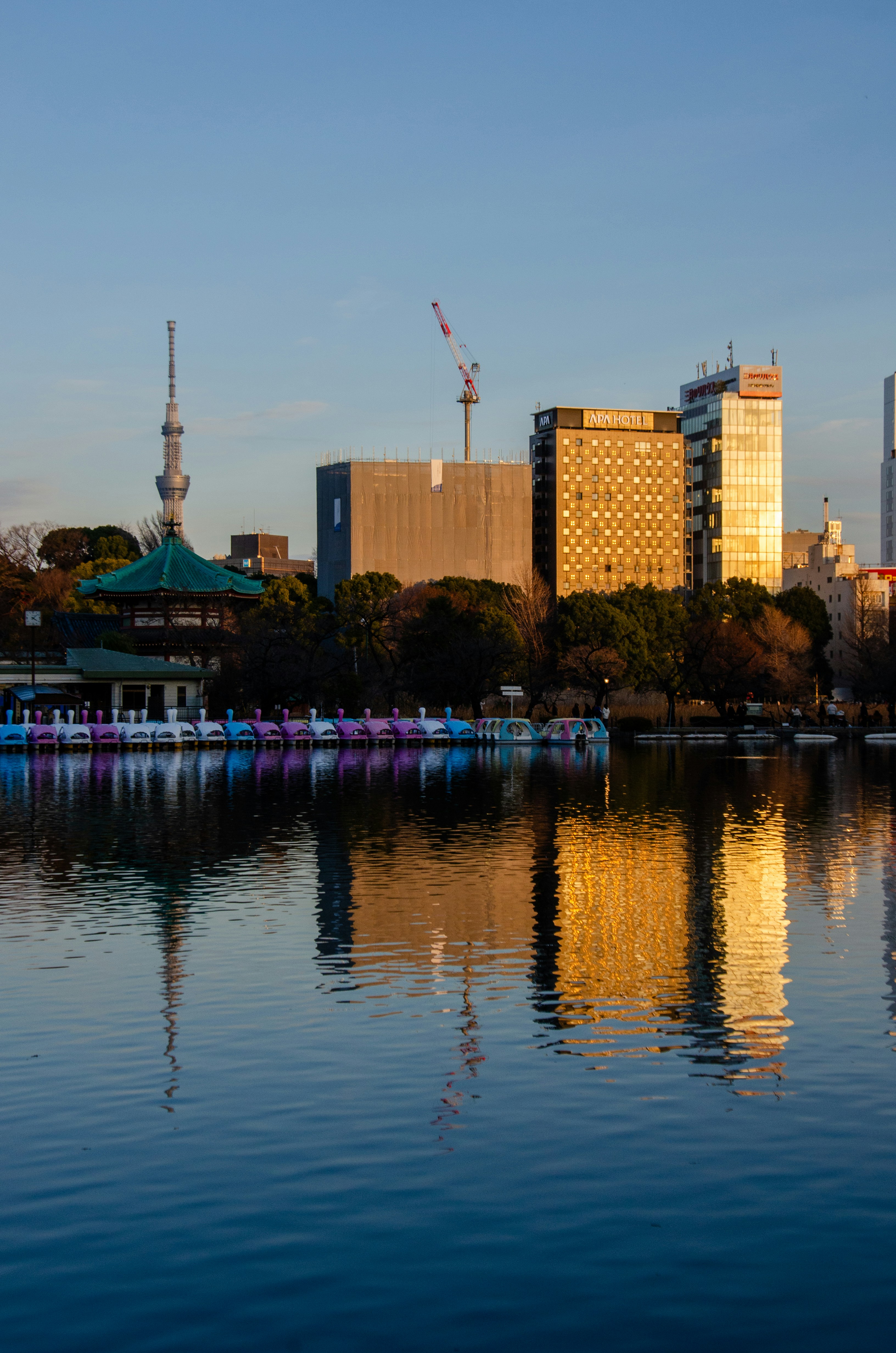 City skyline with lake reflection at sunset