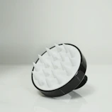 Black and white scalp massager with silicone bristles