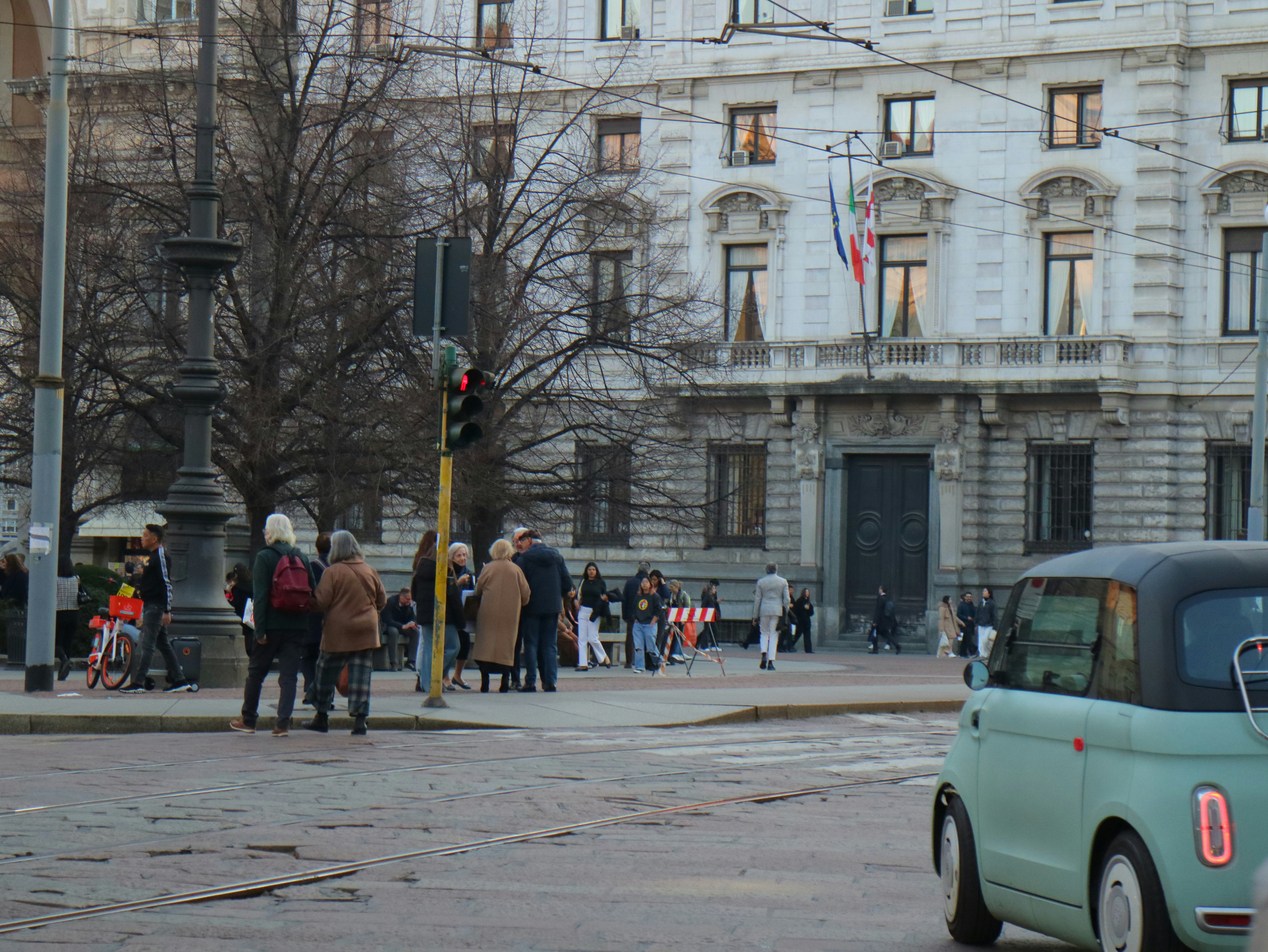 People and a car on a city street