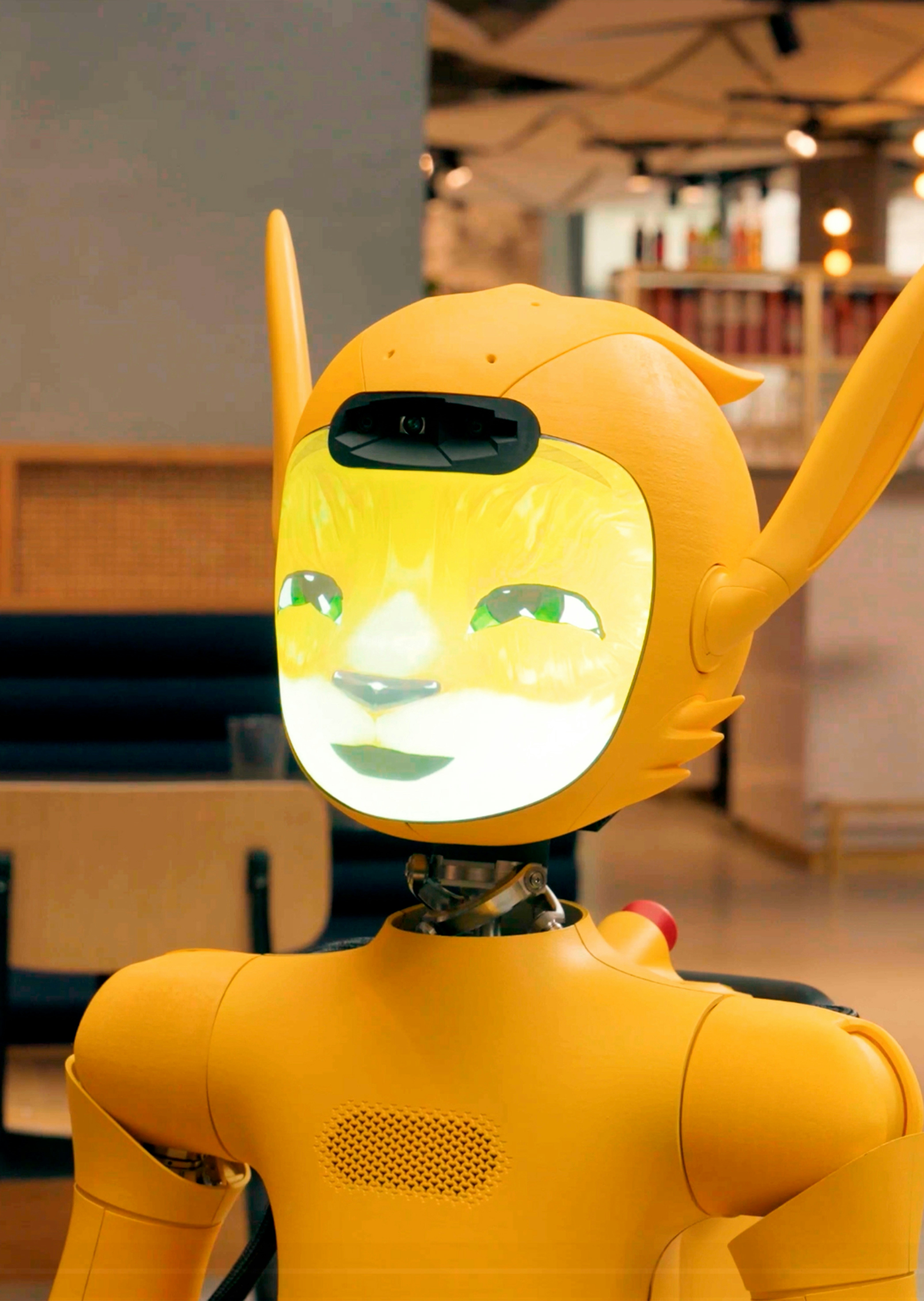 A friendly orange robot with a digital face