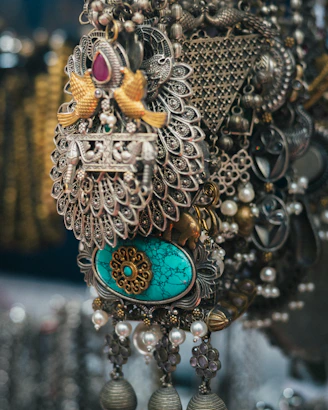 Intricate silver jewelry with turquoise and pearl accents.