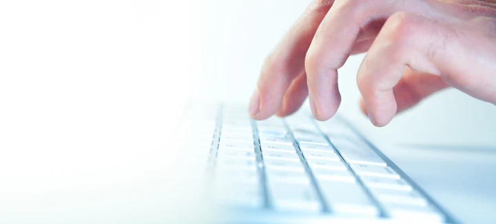 Fingers typing on a computer keyboard — IELTS on computer in Pakistan