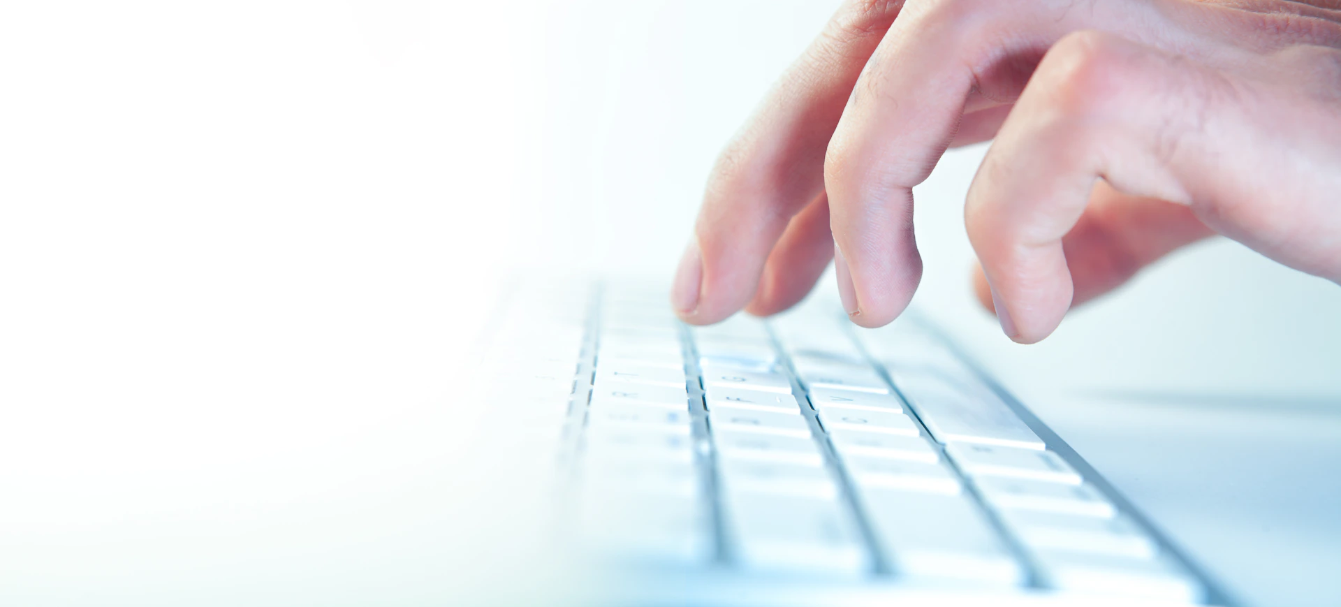 Fingers typing on a computer keyboard