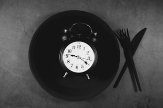 Alarm clock on a plate with cutlery