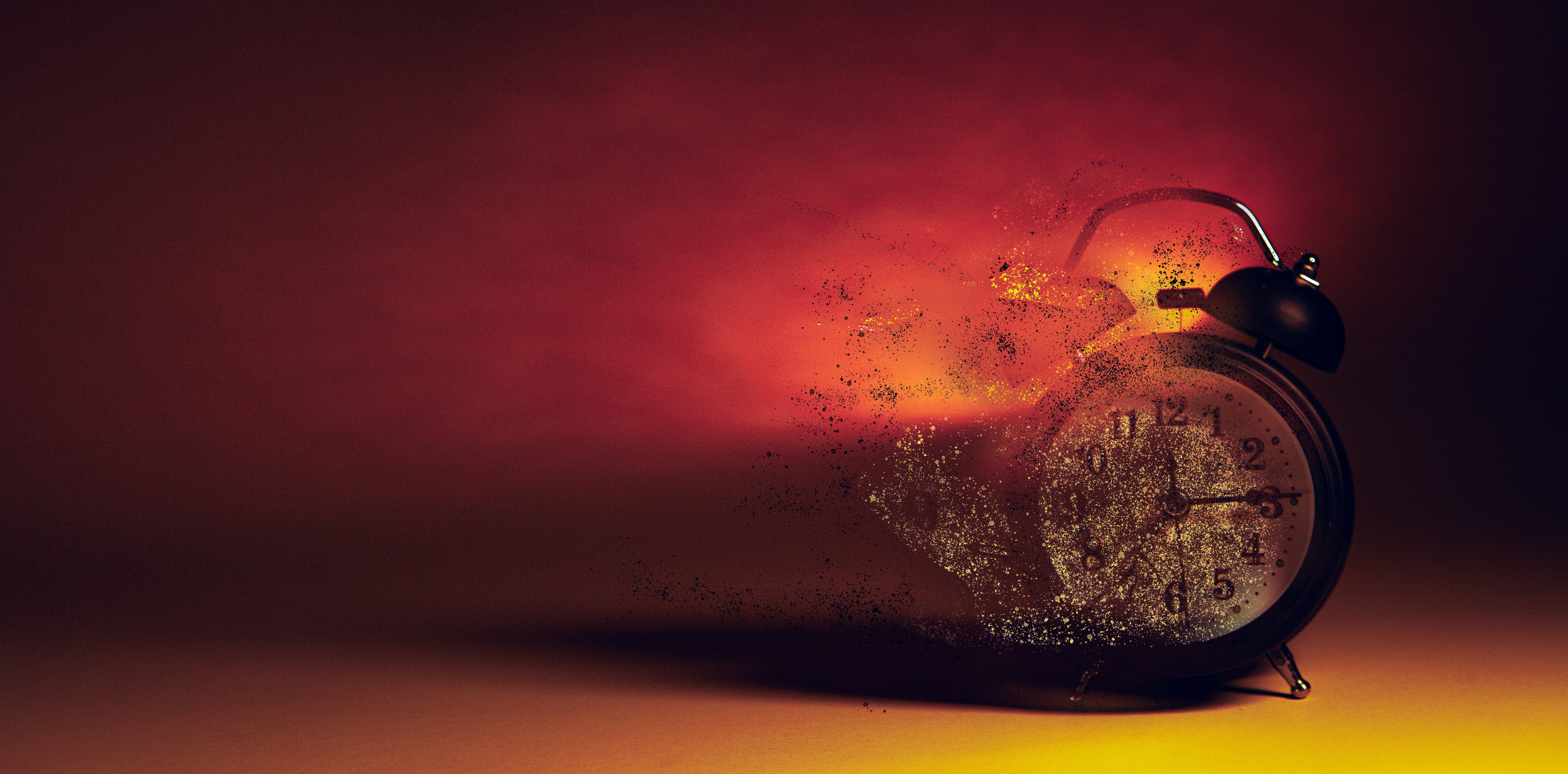 Alarm clock disintegrating into smoke and embers.