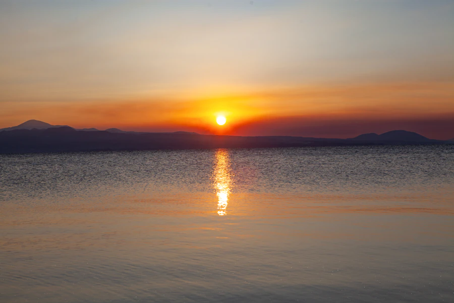Sunrise over a calm body of water