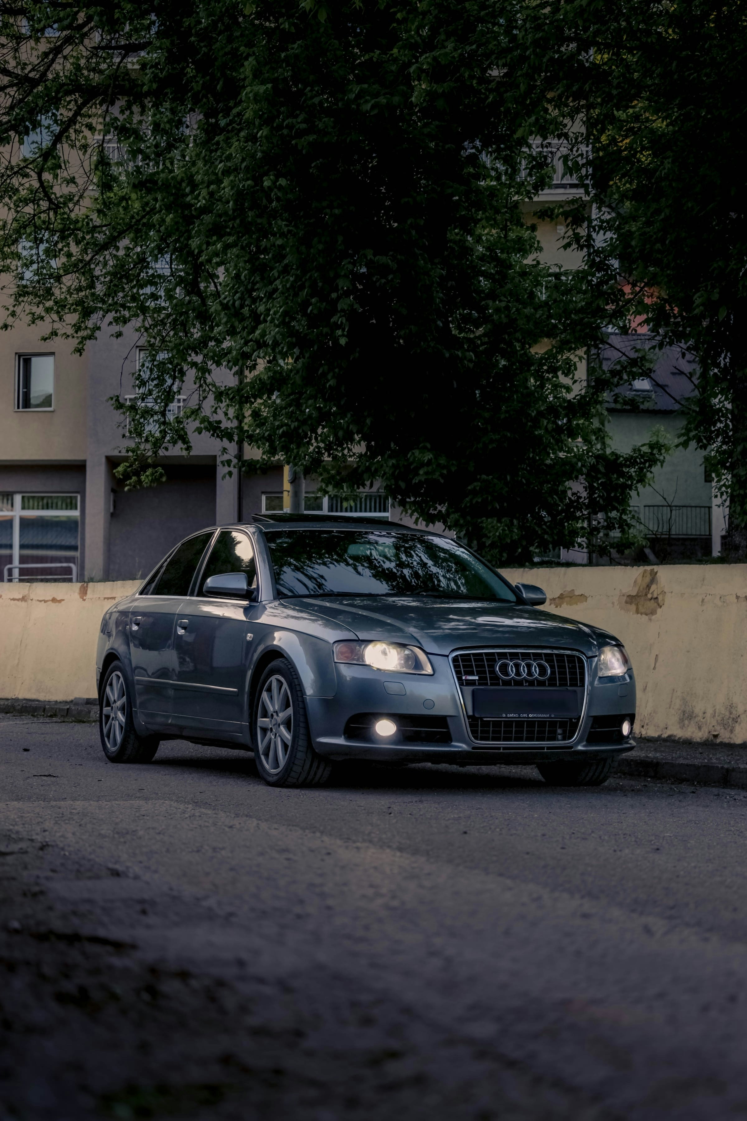A gray audi sedan parked on a street.