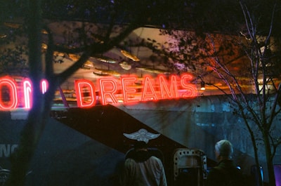 Neon sign with the word dreams at night