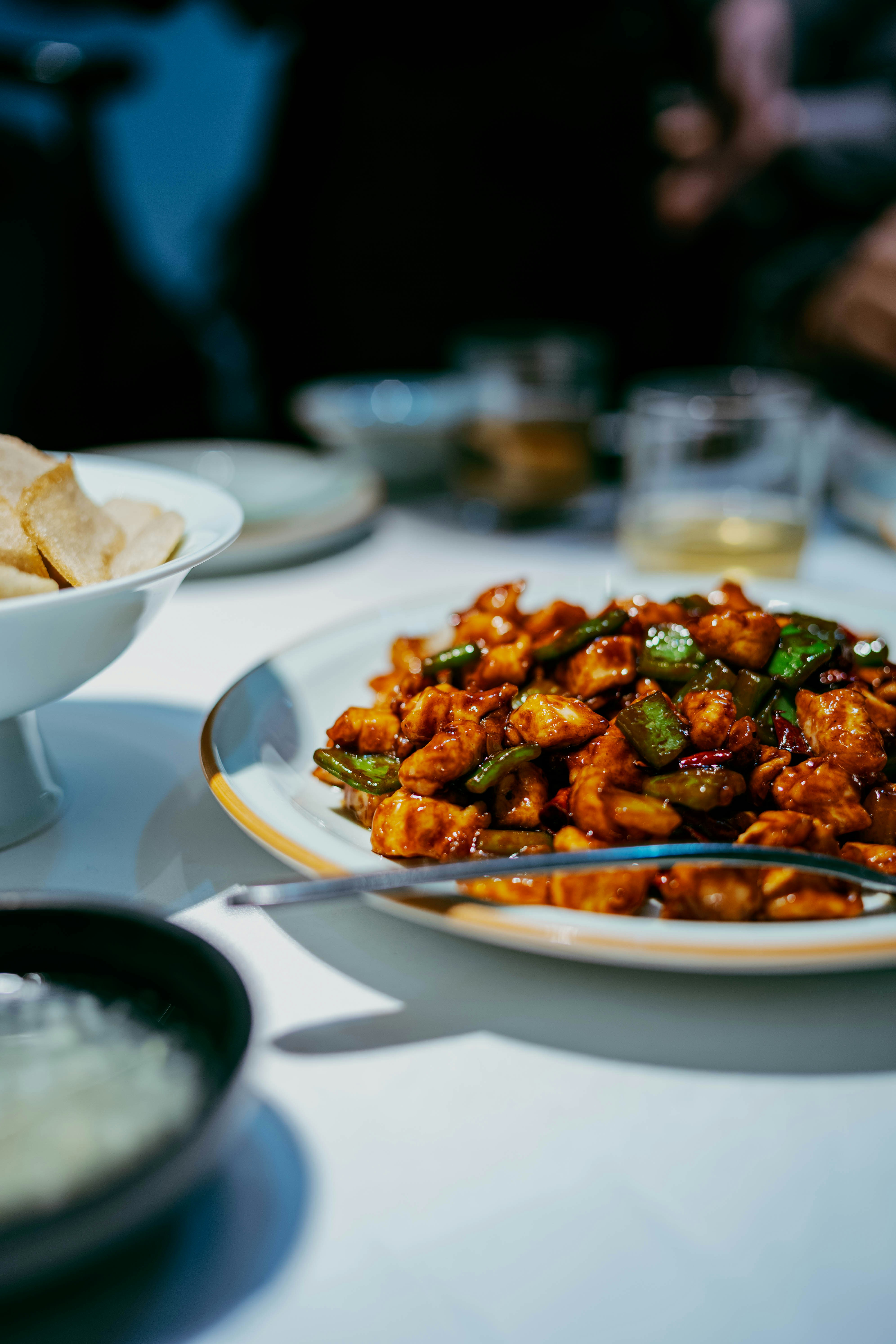 A plate of glistening chicken and green peppers.
