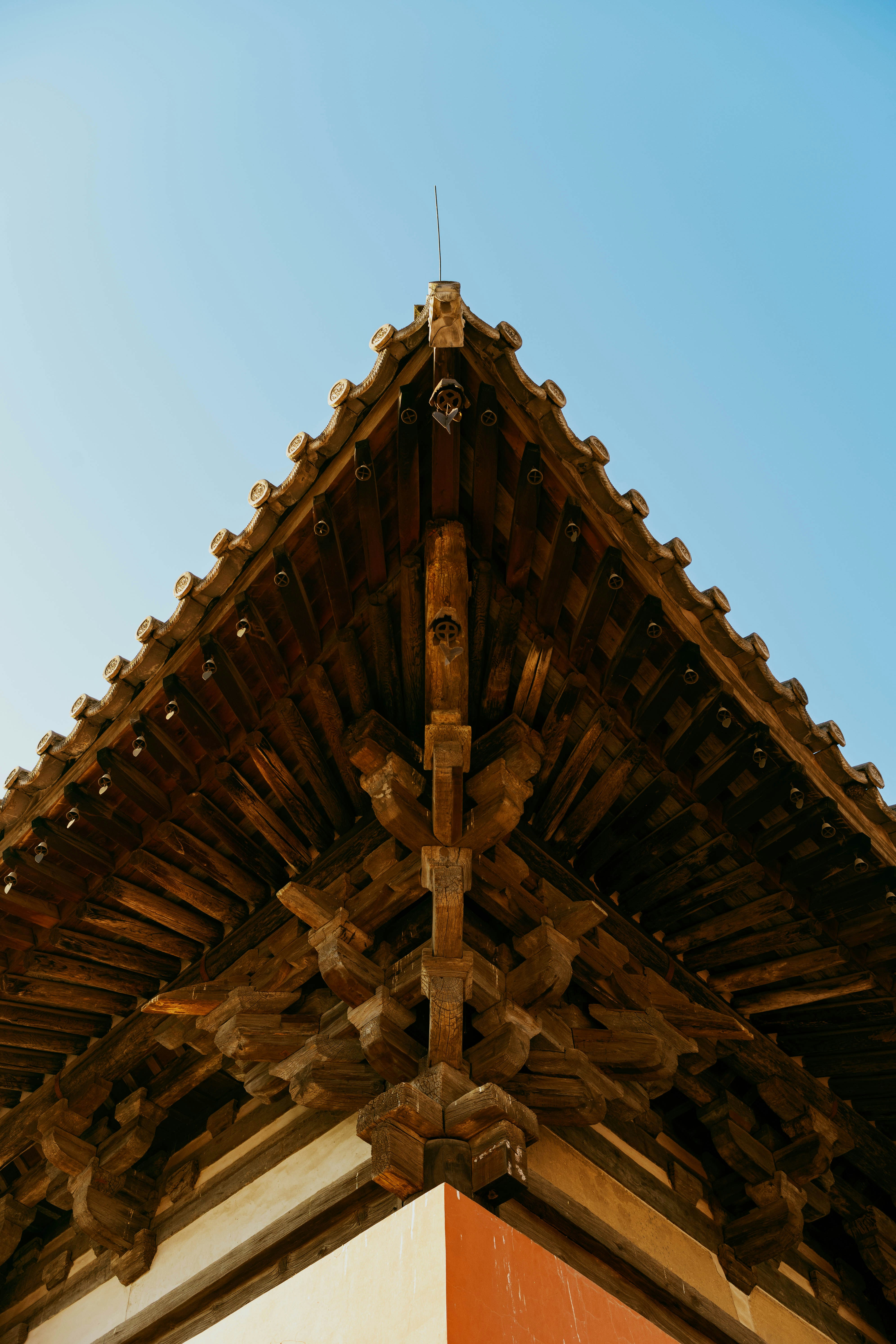 Intricate wooden eaves of a traditional building against sky
