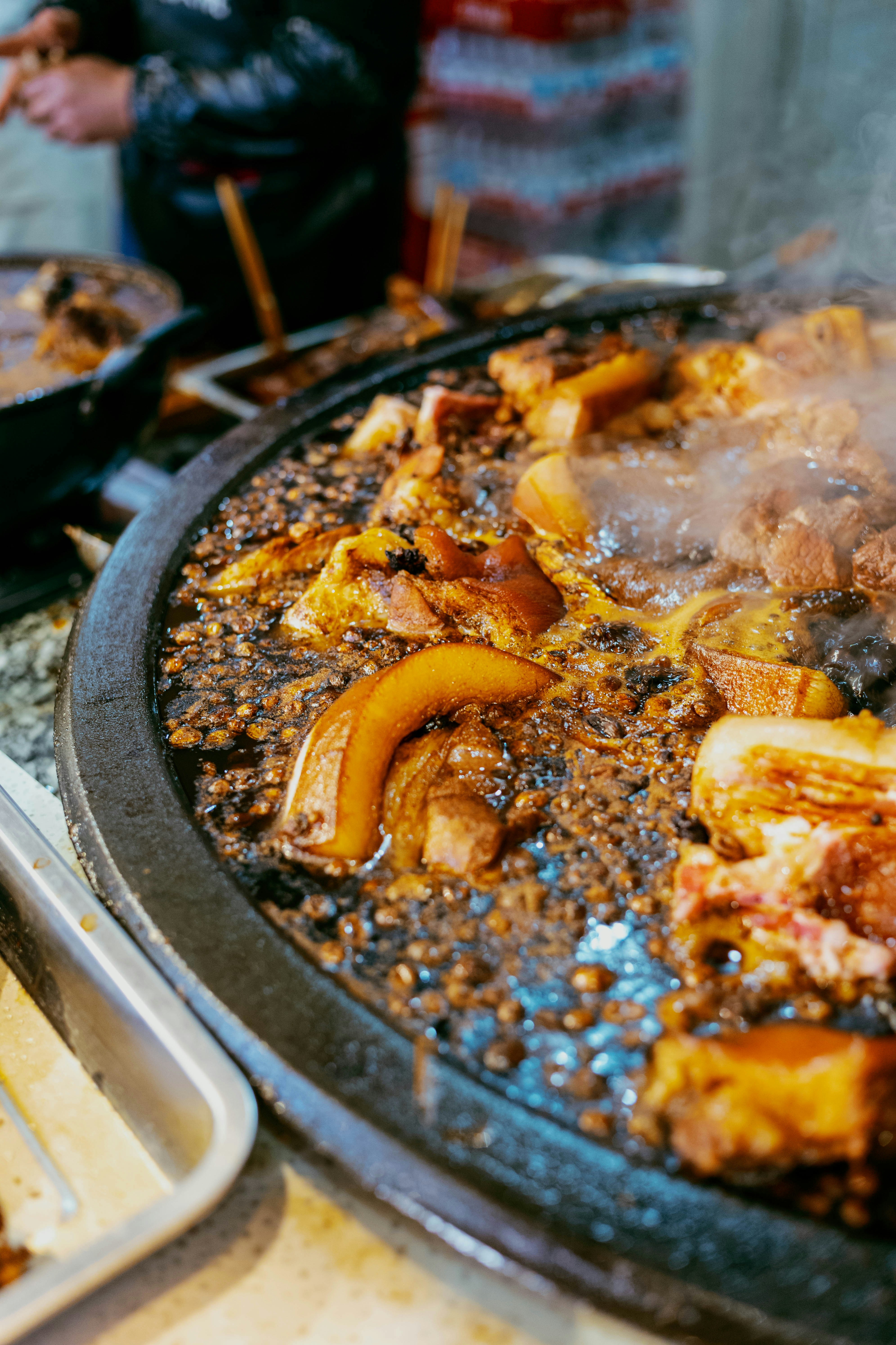 Pork belly pieces simmering in a large pan.