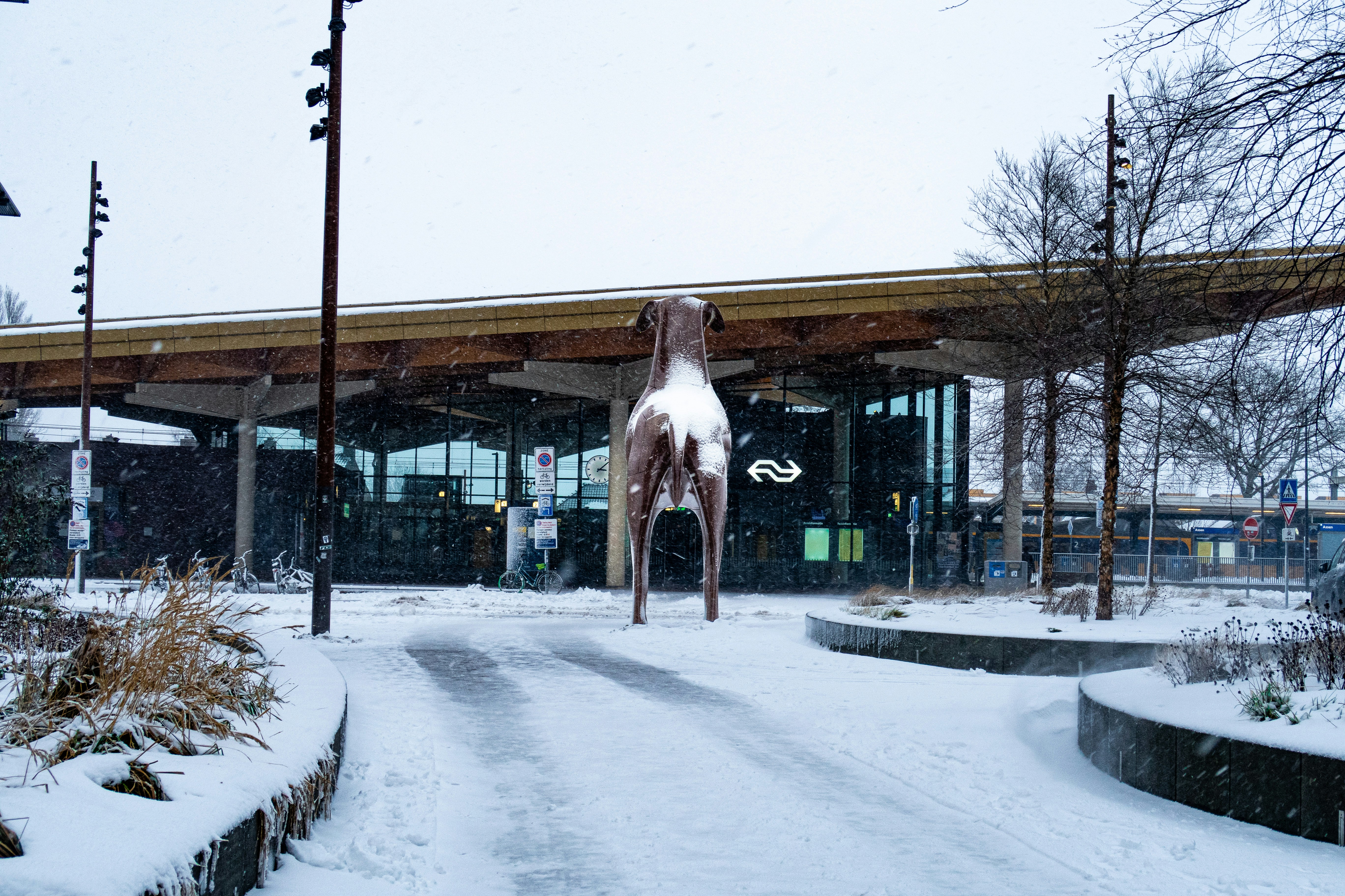 A statue of a horse in the snow