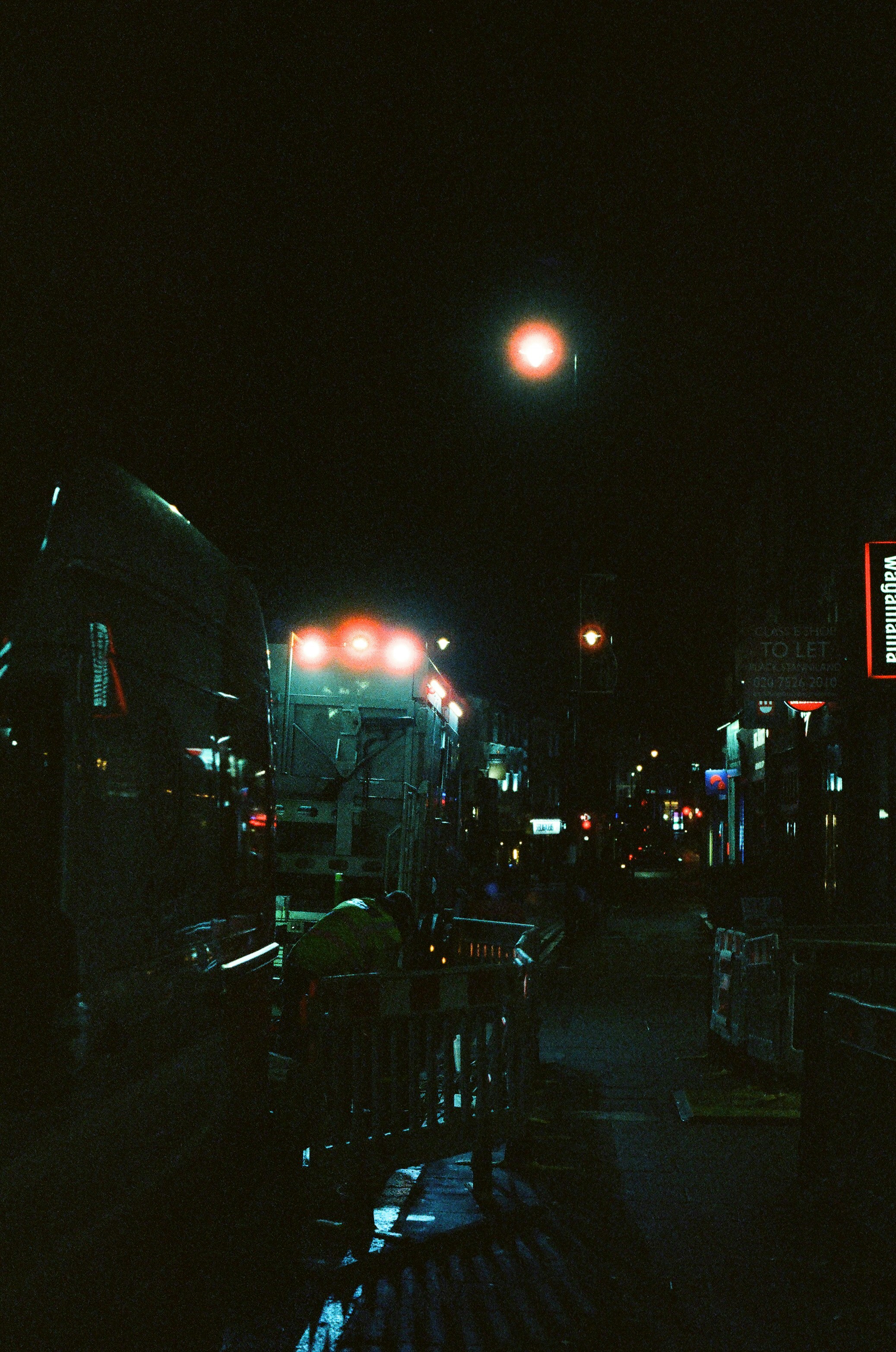 Street scene at night with glowing lights