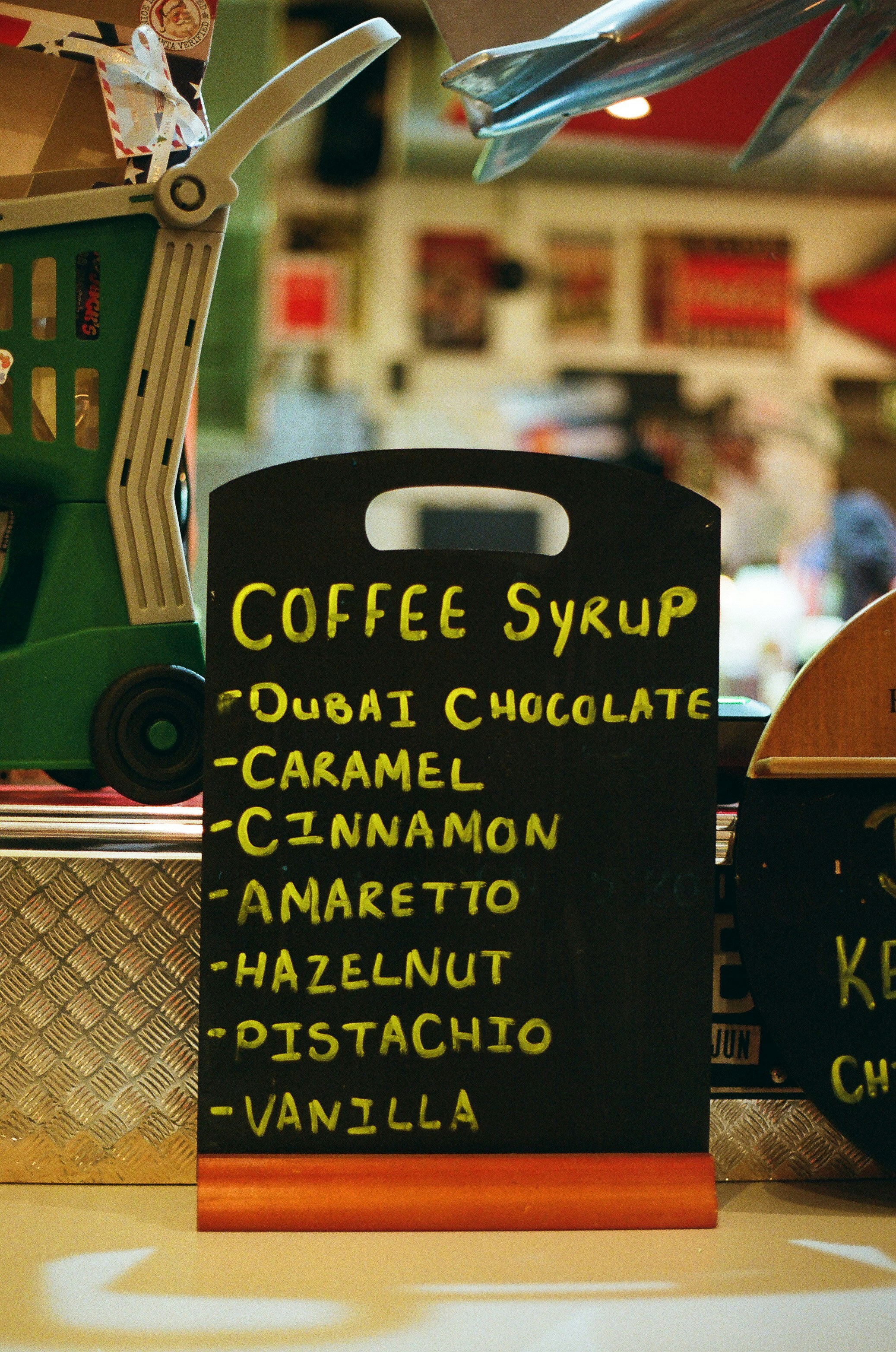 Chalkboard menu lists coffee syrup flavors