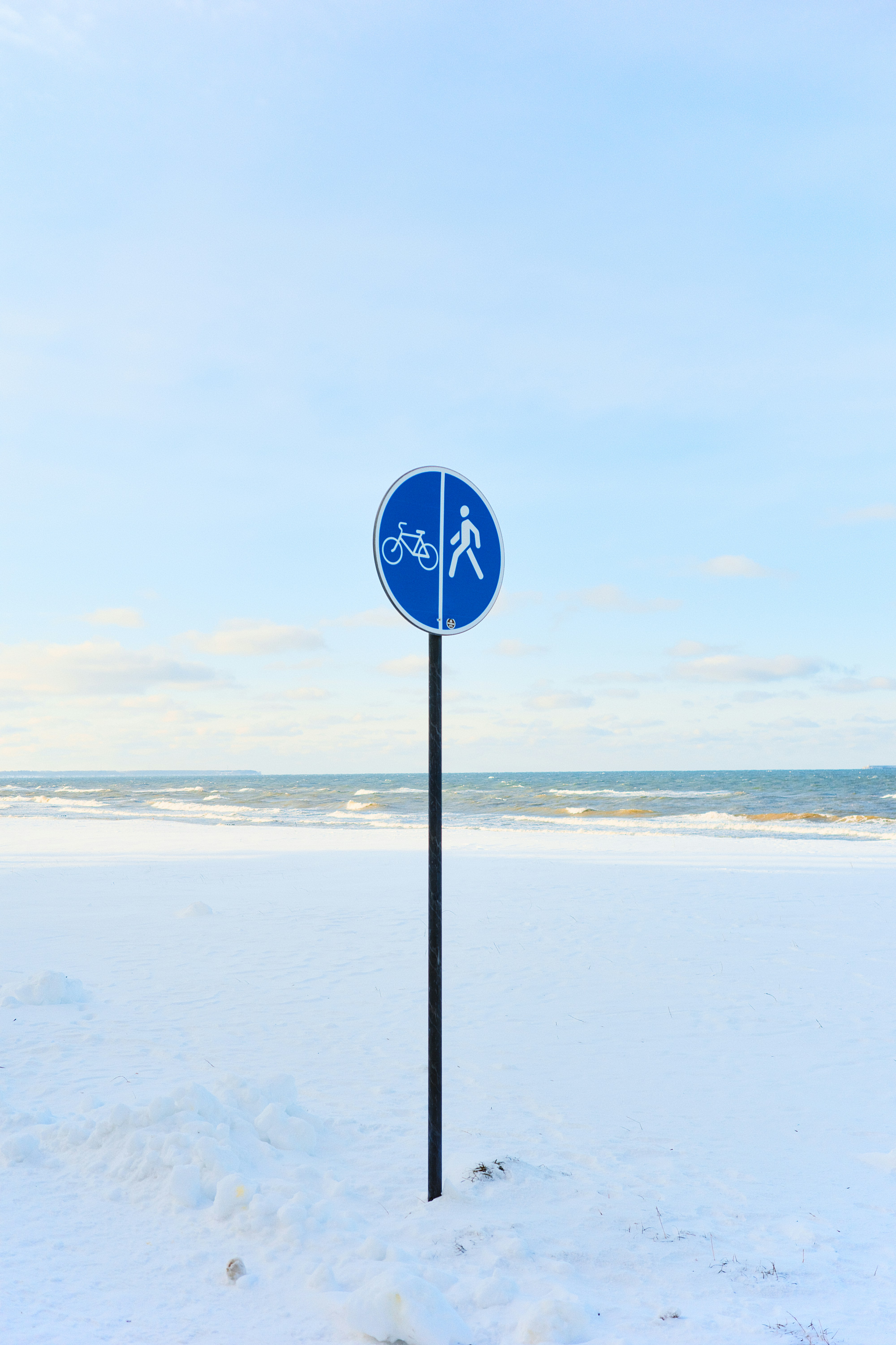 Bicycle and pedestrian path sign in snow