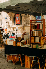 Outdoor book stall with shelves and tables of books.