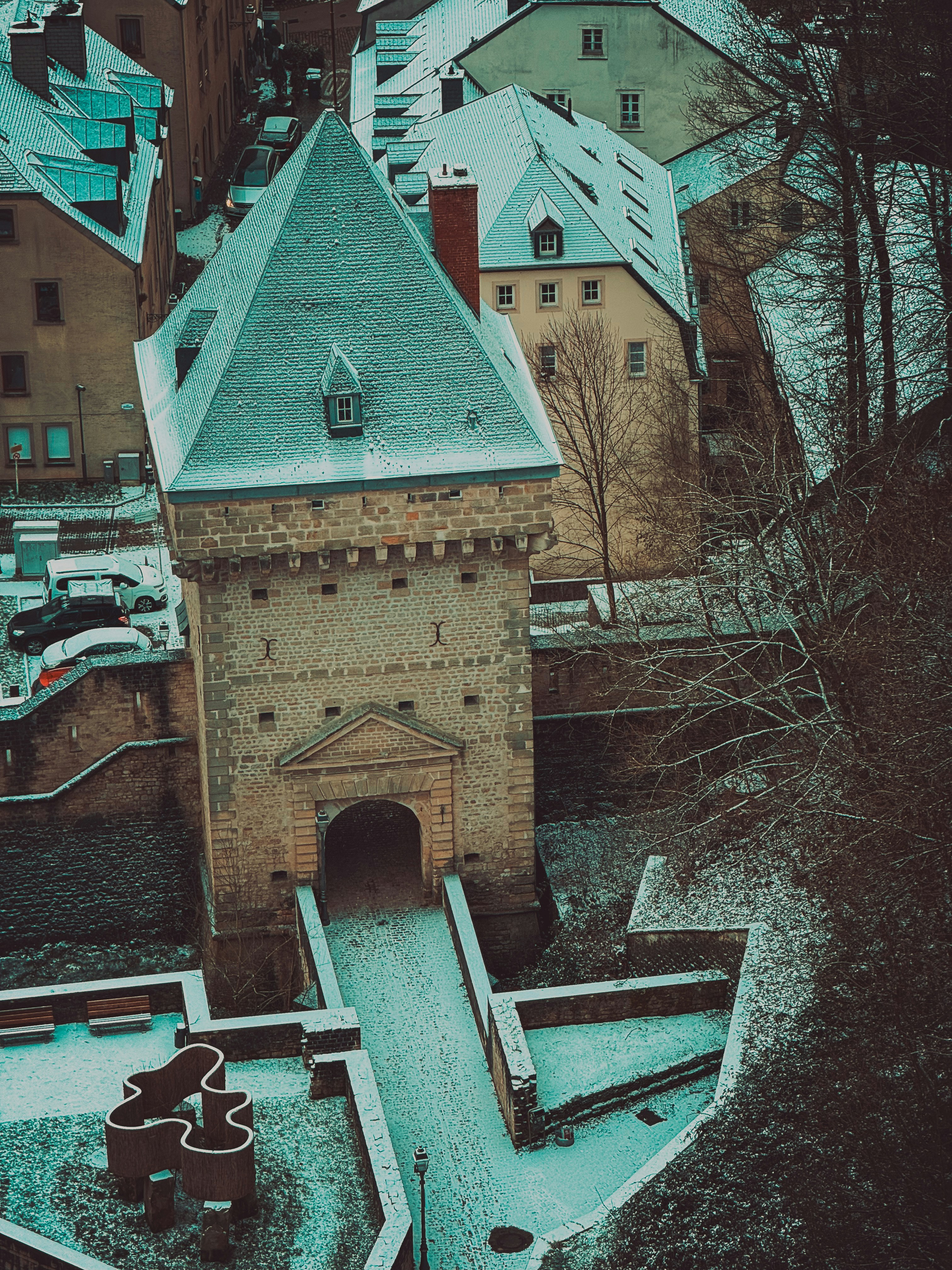Snow-covered historic tower and buildings in winter.